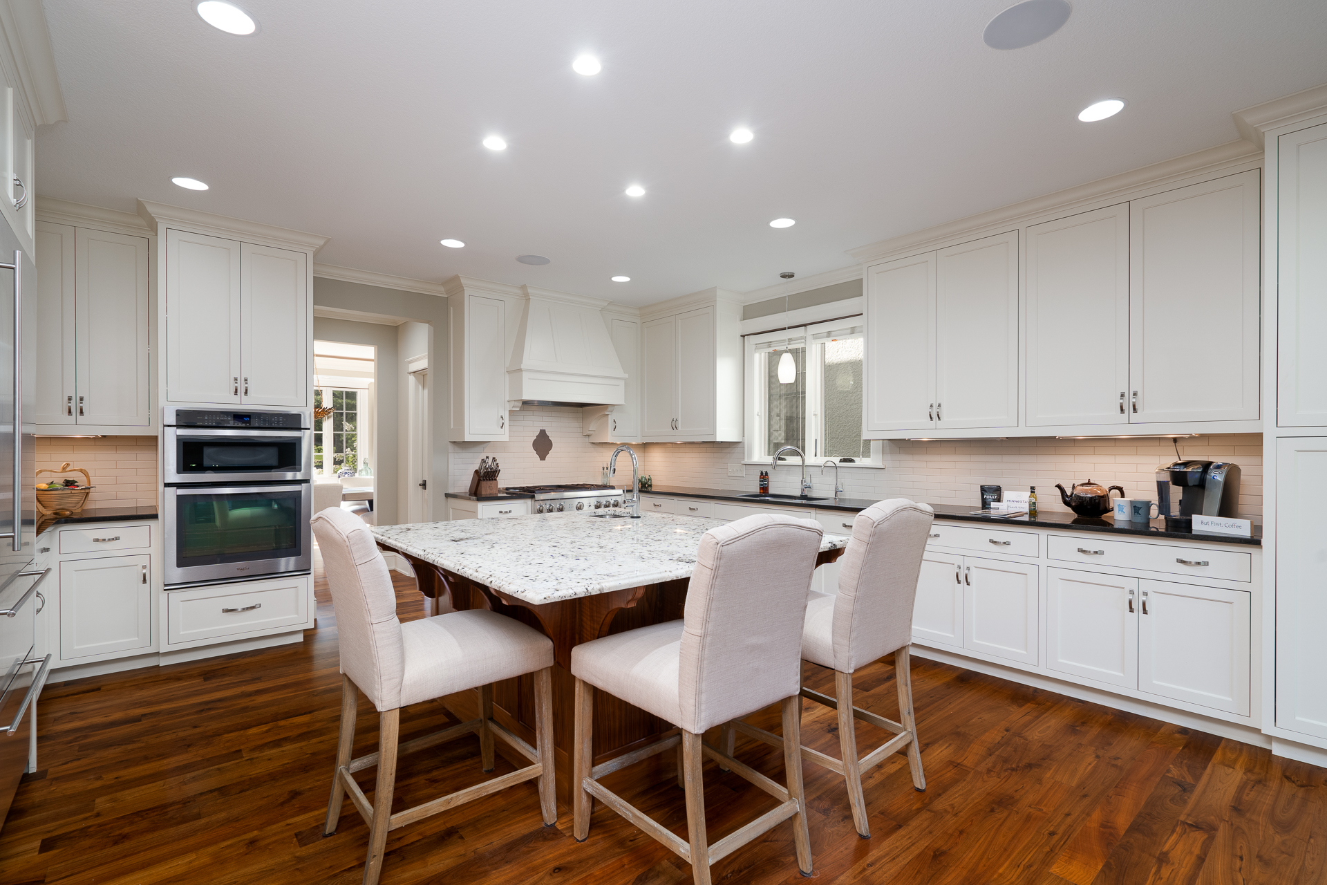 A modern kitchen featuring a spacious island and elegant white cabinetry.