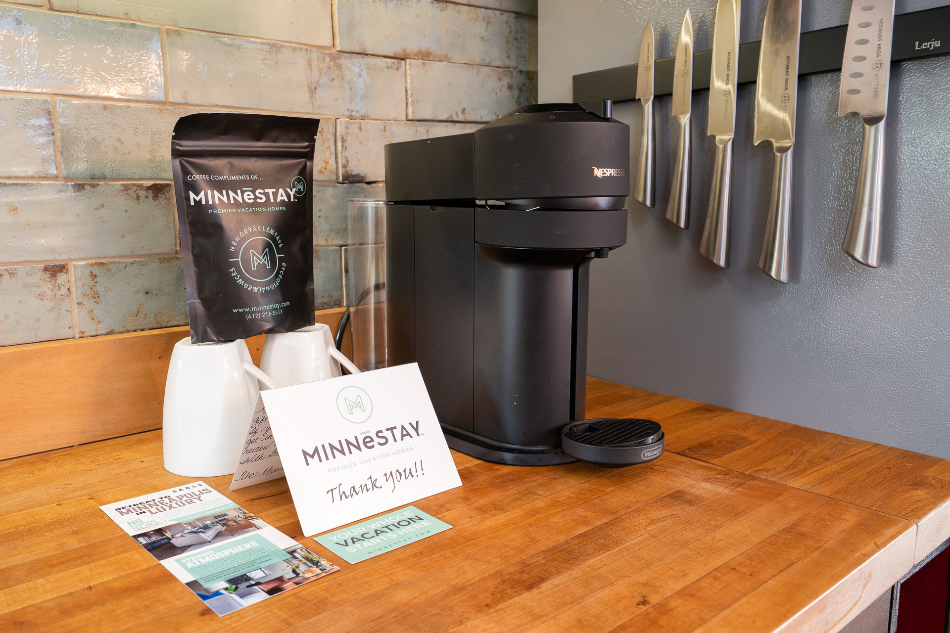 A welcoming kitchen corner featuring a Nespresso coffee maker and MINNĒSTAY amenities.