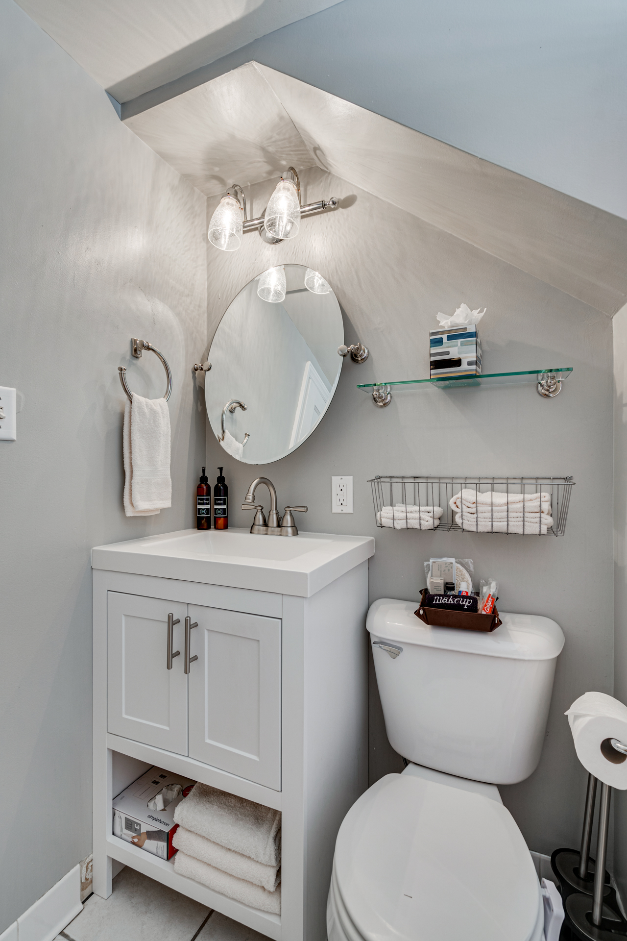 A stylish compact bathroom featuring modern fixtures and smart storage solutions.