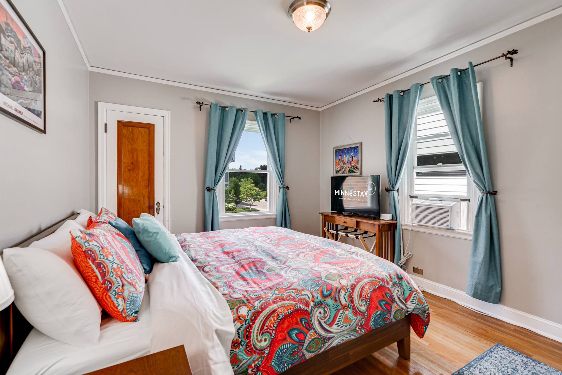 Vibrant and cozy bedroom with a colorful comforter and modern amenities.