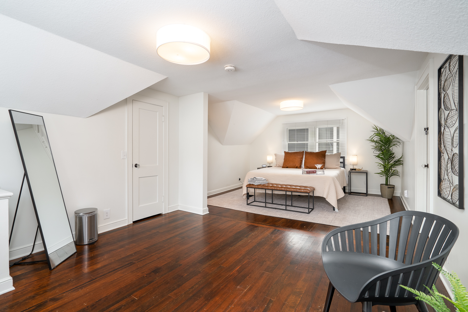 A cozy bedroom featuring modern decor and warm lighting.