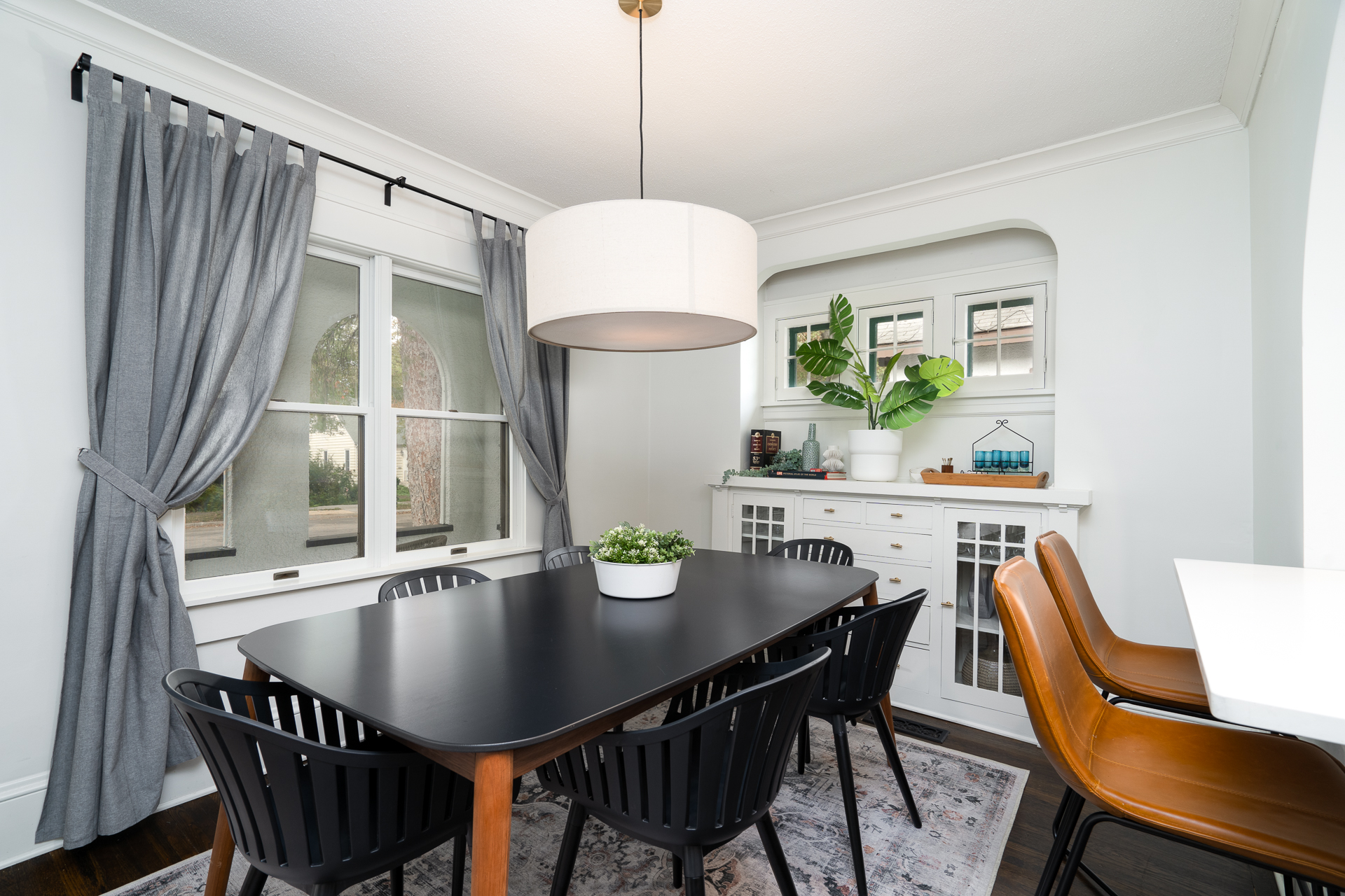 A modern dining area with elegant furnishings and warm decor.