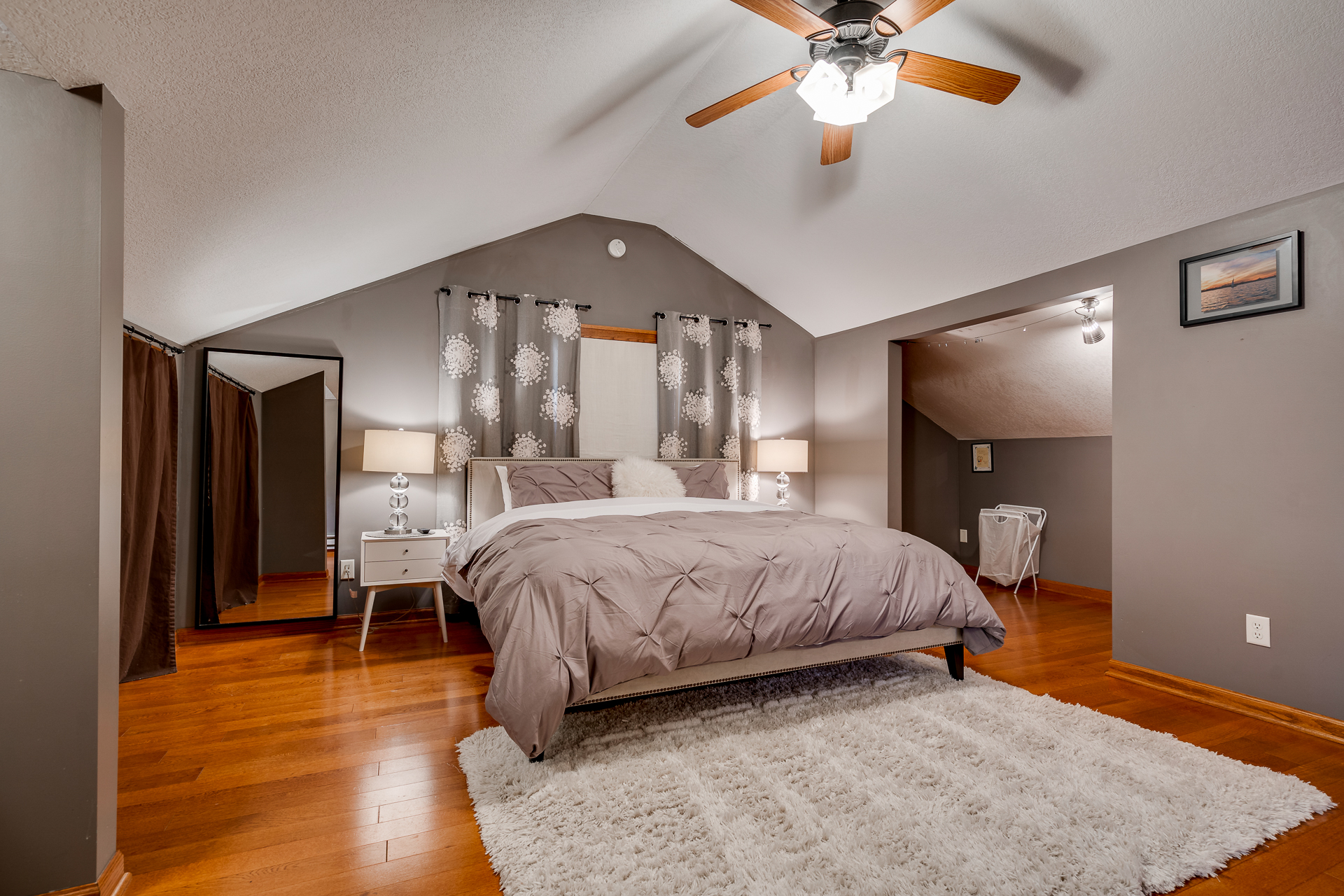 A cozy bedroom with elegant decor and warm wooden accents.