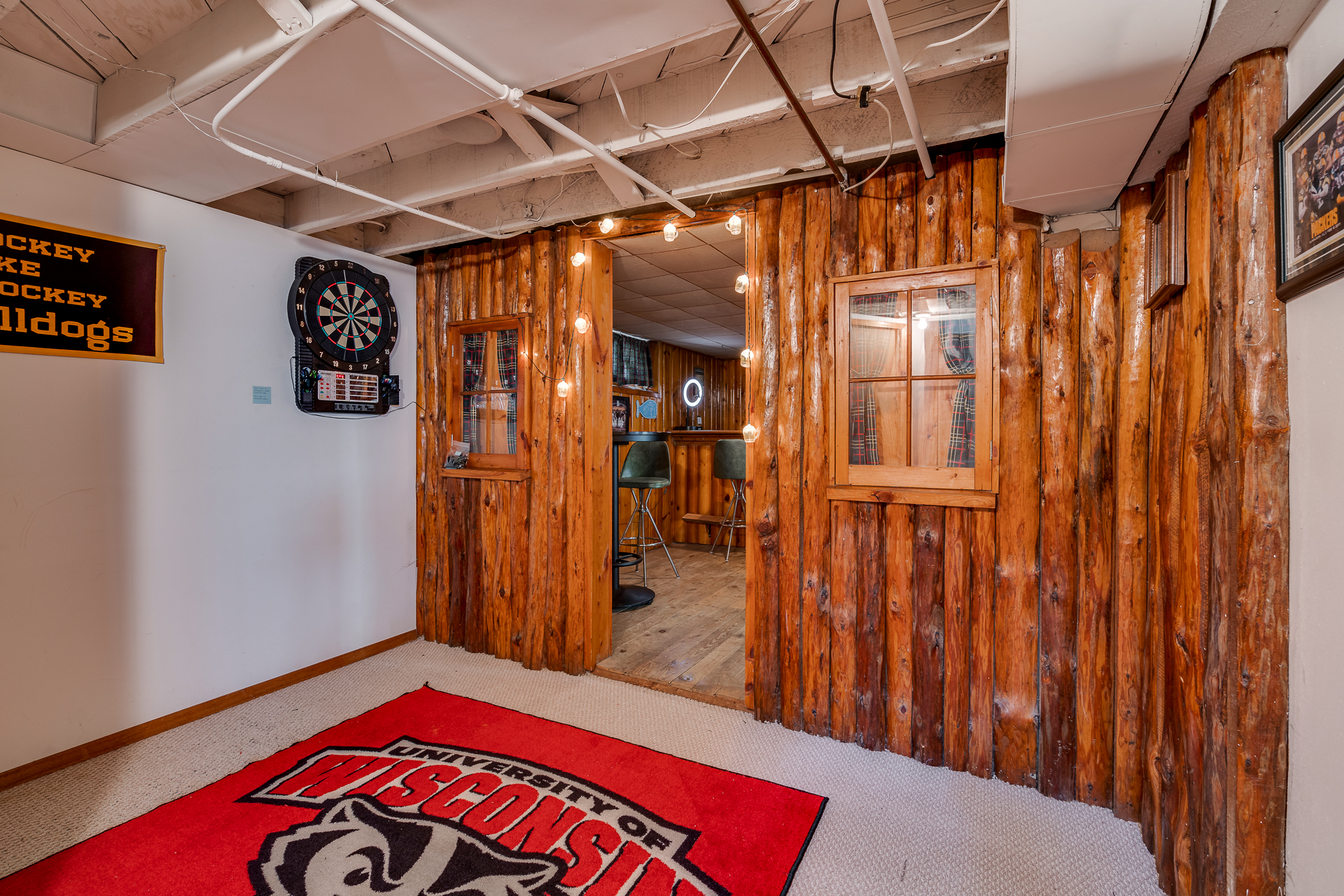 A cozy basement entrance with rustic wooden features and sports decor.