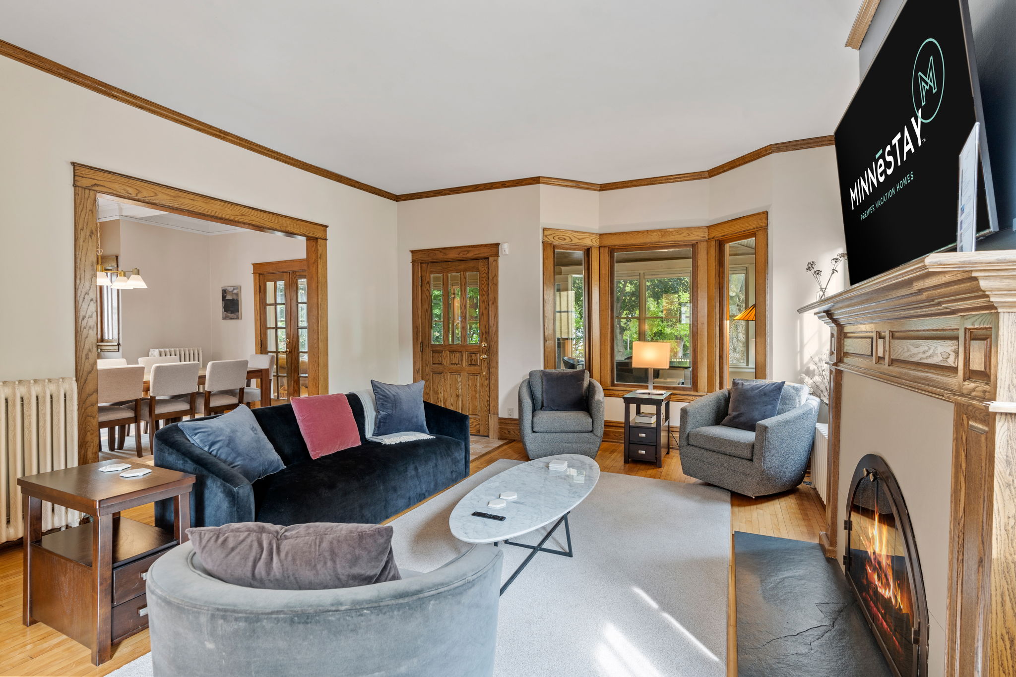 A cozy living room featuring modern and classic decor with a fireplace and stylish furniture.