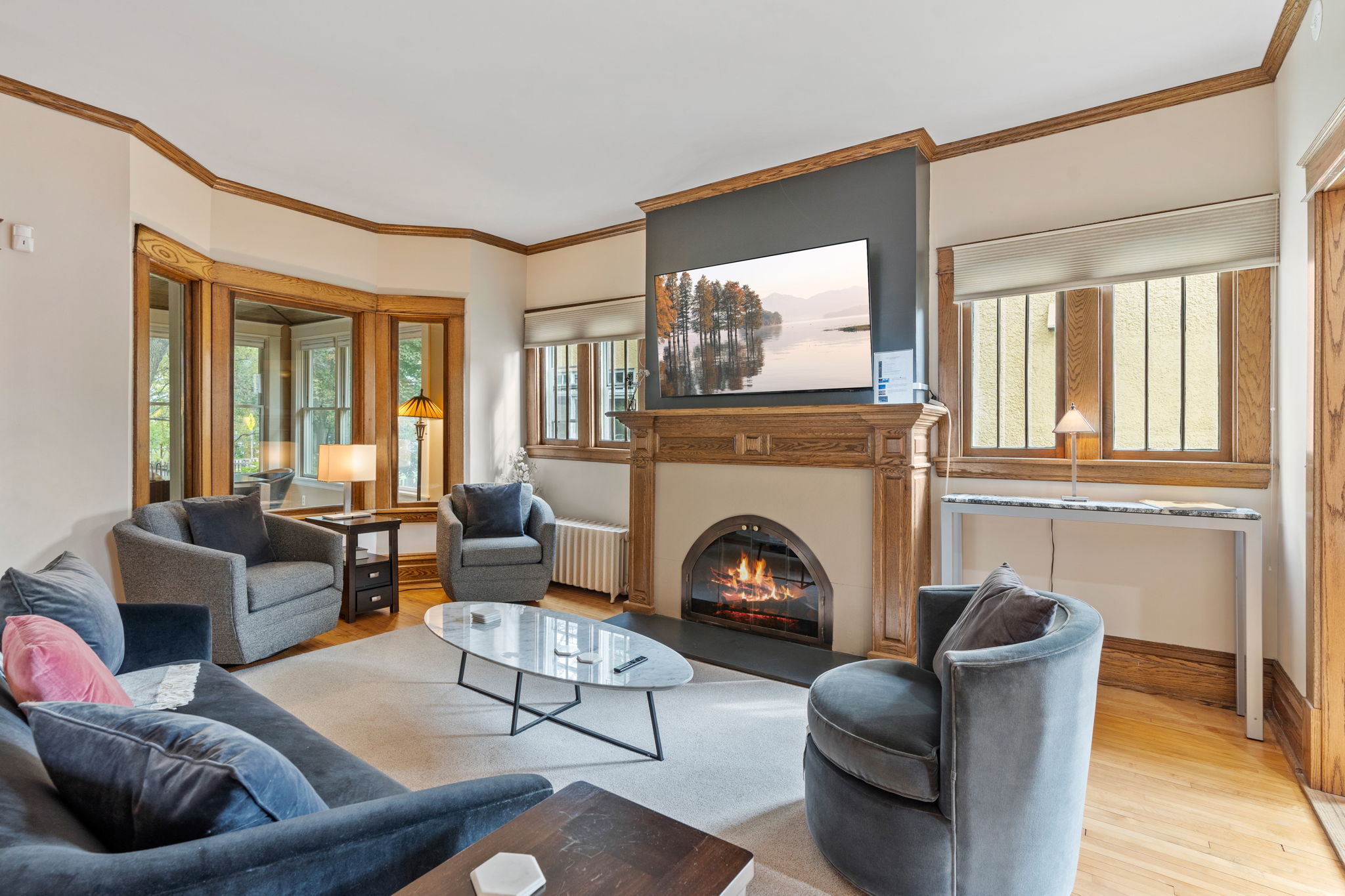 A warm and inviting living room featuring plush seating and a cozy fireplace.