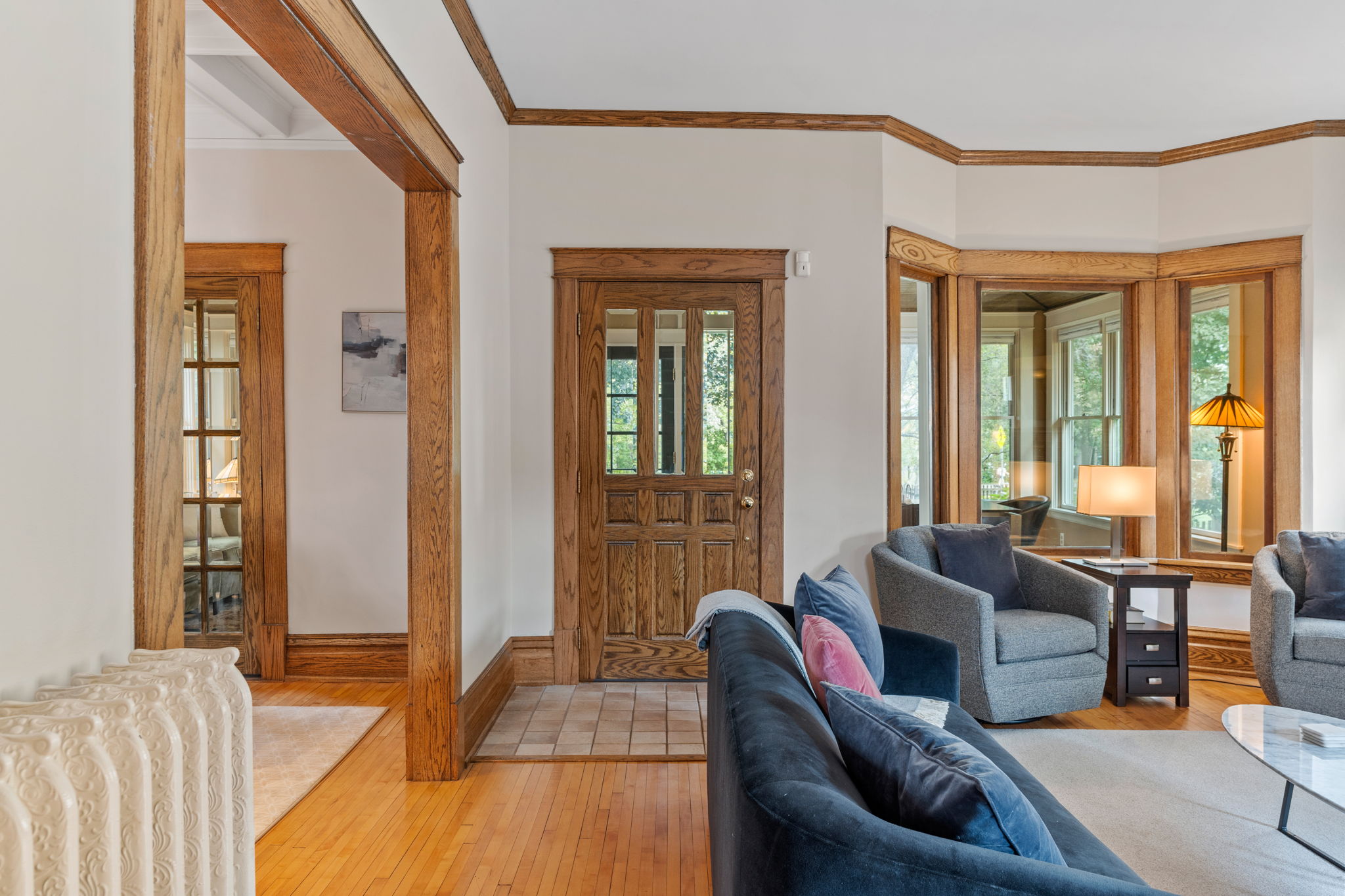 Cozy living room with elegant wood details and warm lighting.