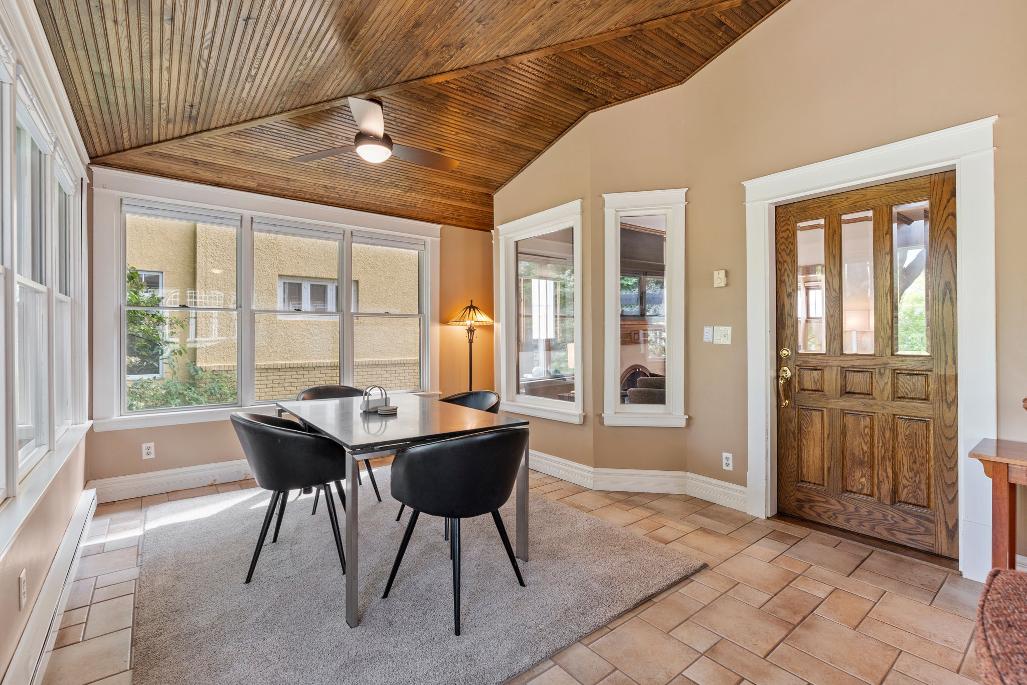 Cozy dining area with wooden ceiling and natural light.