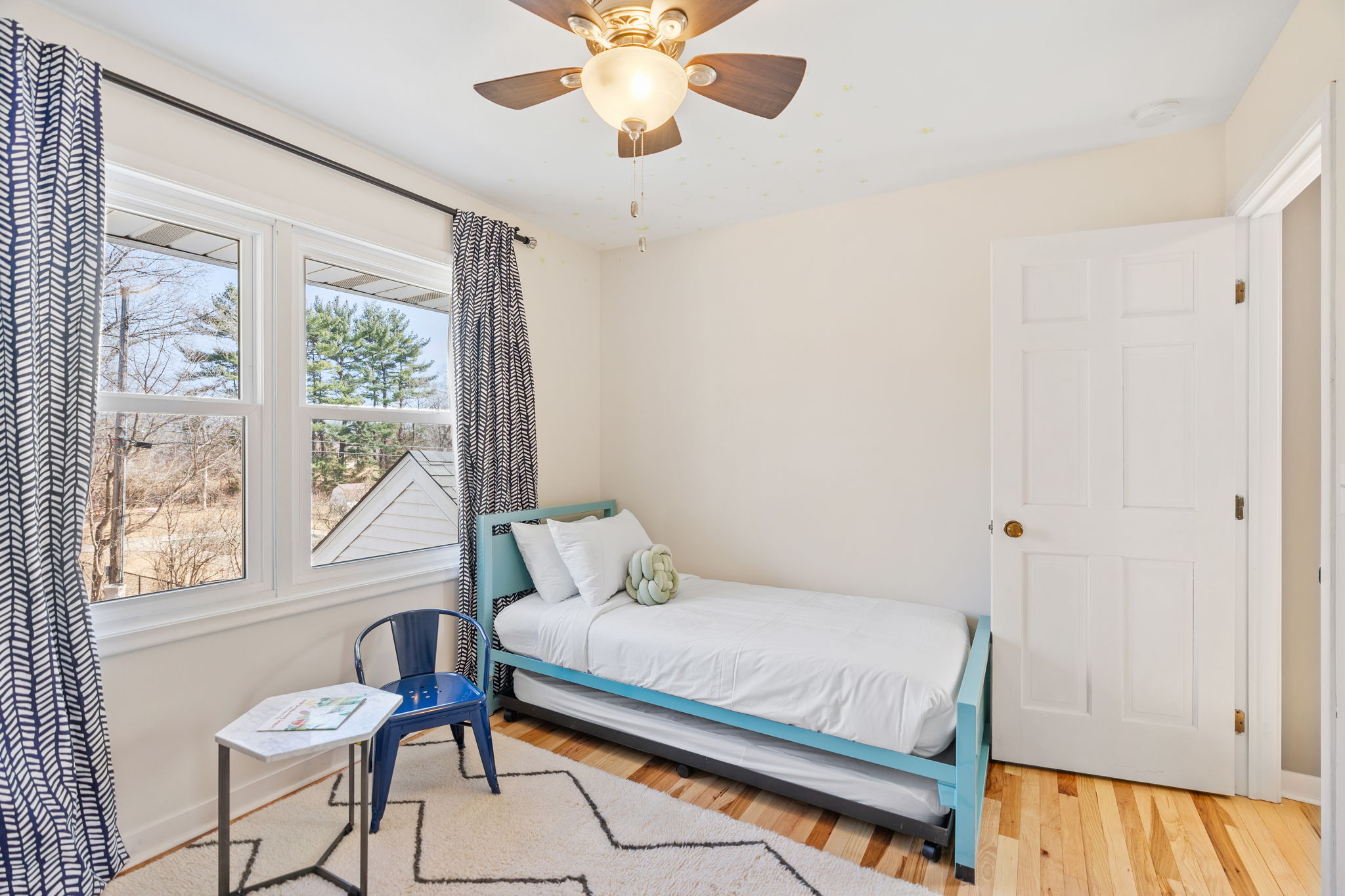 A serene and stylish bedroom with a cozy twin bed and modern decor.