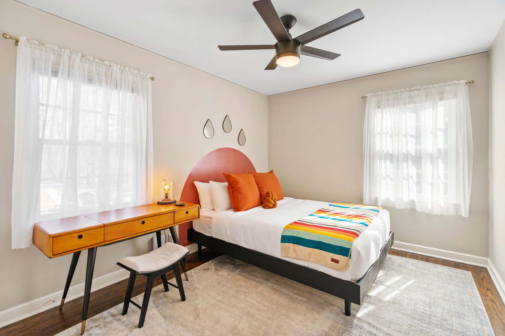 A cozy and modern bedroom filled with warm tones and colorful accents.