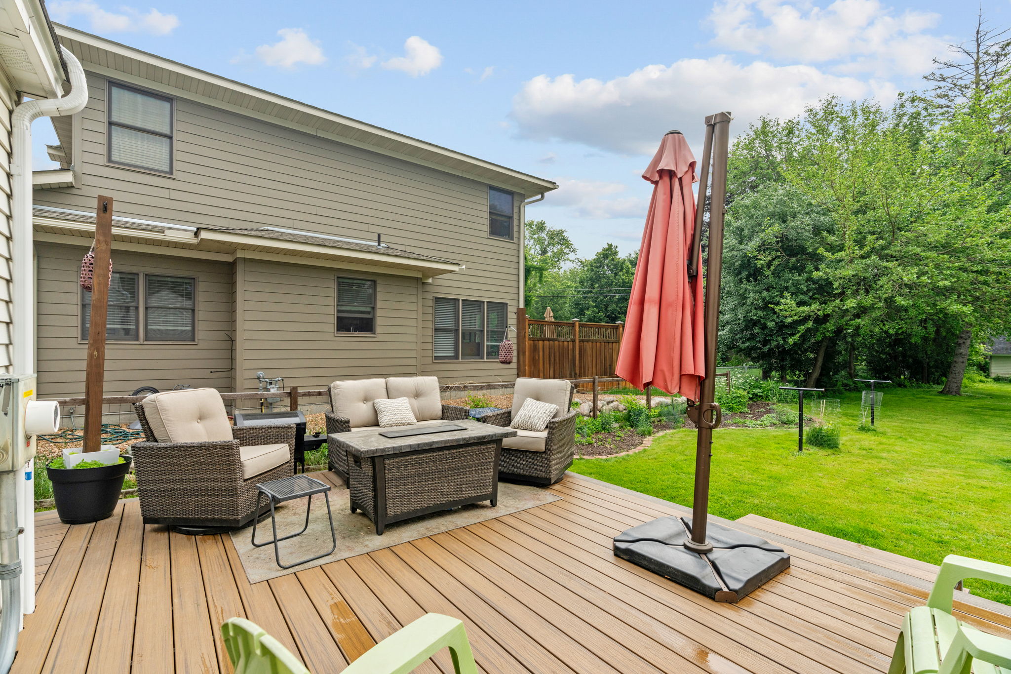 Cozy outdoor deck area with comfortable seating and a large umbrella.
