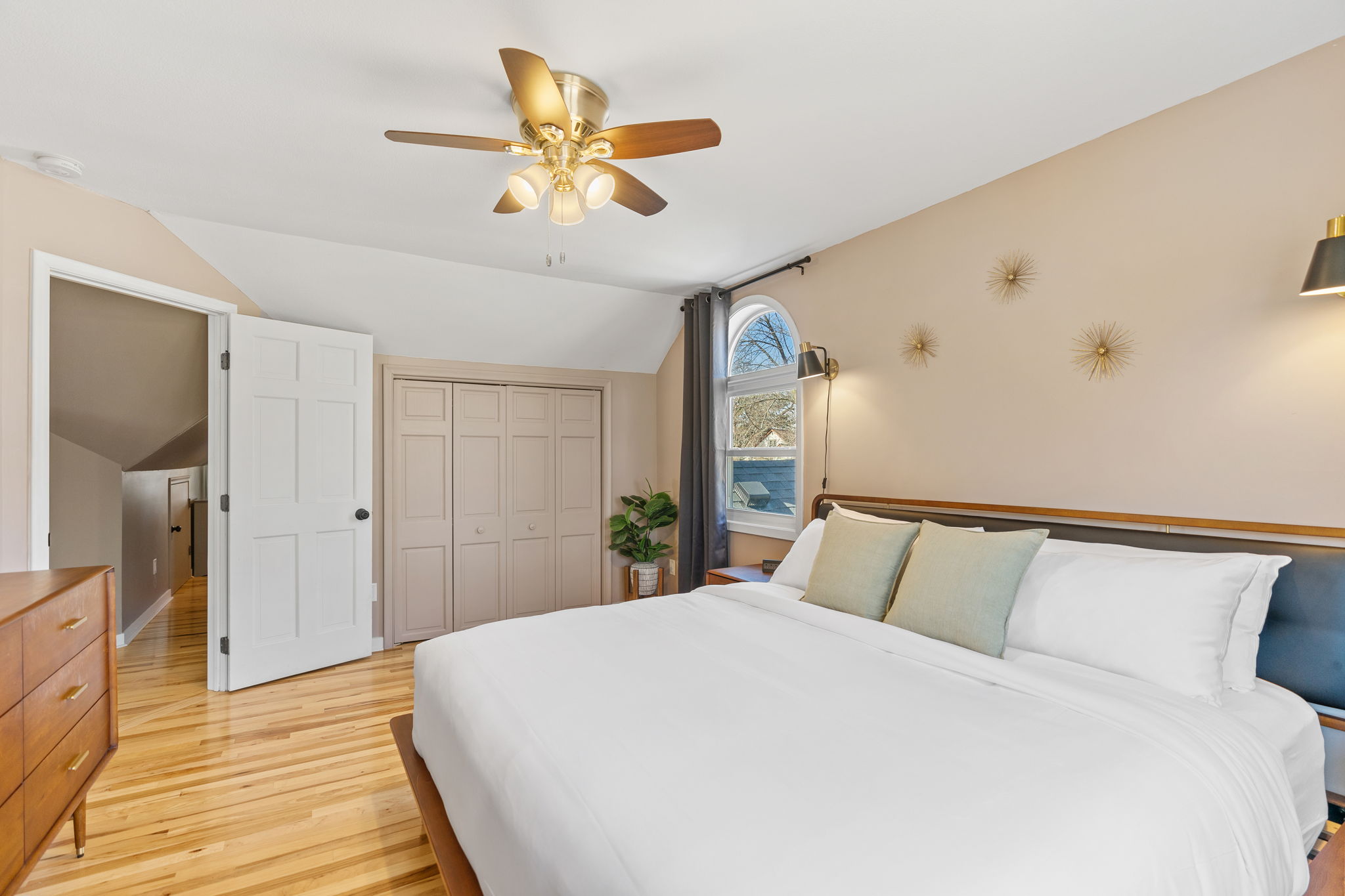A stylish and cozy bedroom featuring a neatly made bed and modern decor.