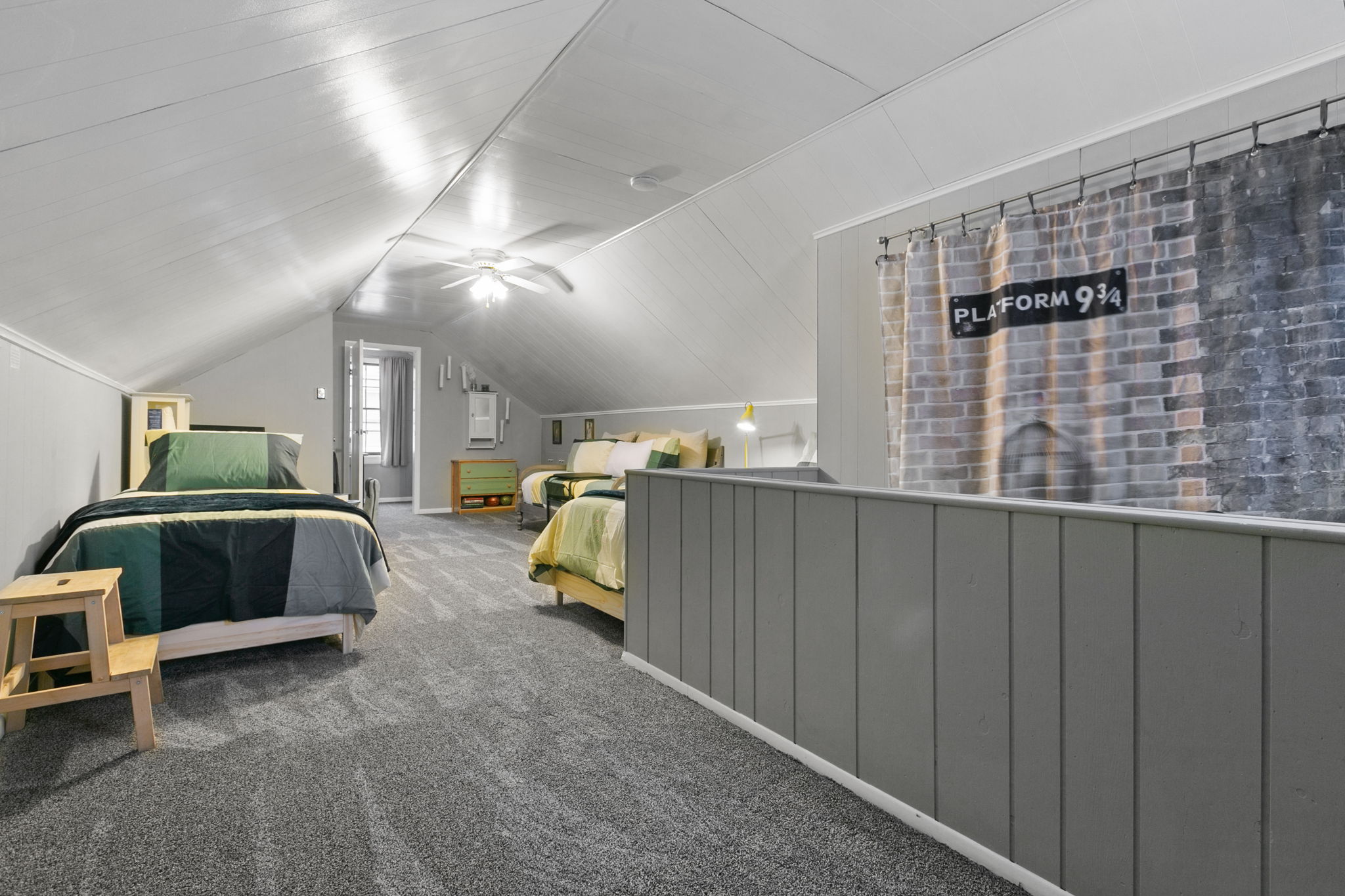 Cozy loft bedroom with themed décor and modern touches.