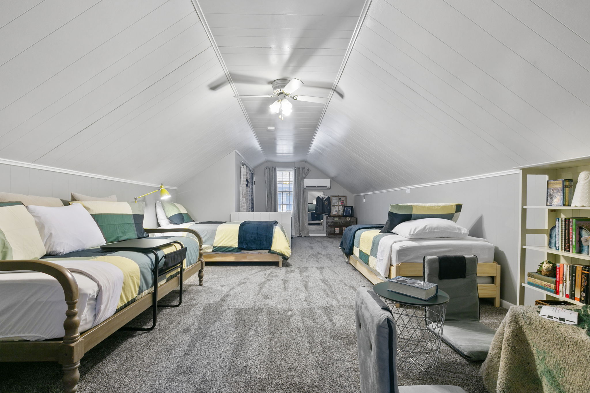 Cozy and contemporary attic space with styled beds and inviting decor.
