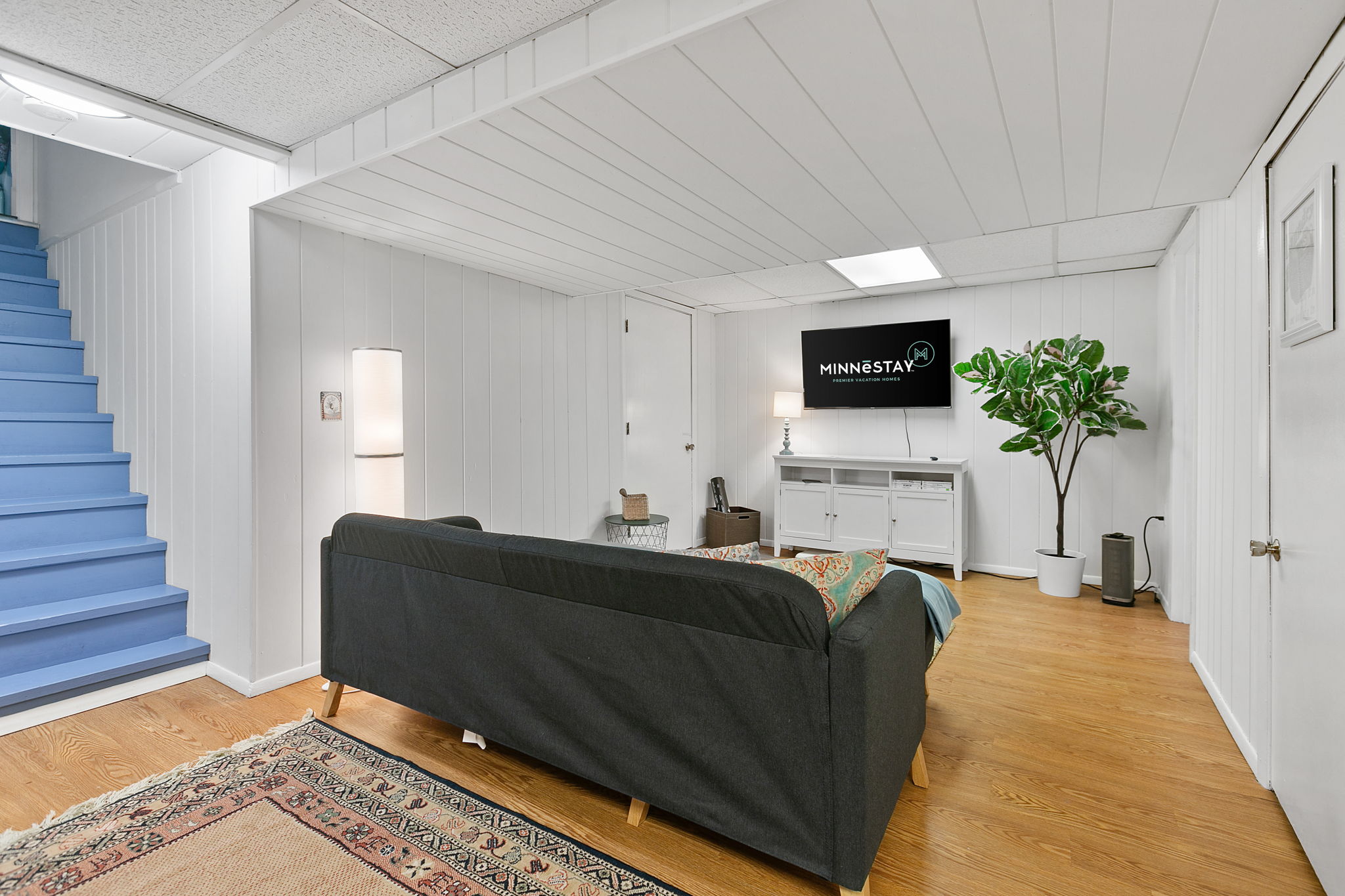 A cozy basement living area with modern decor and colorful accents.