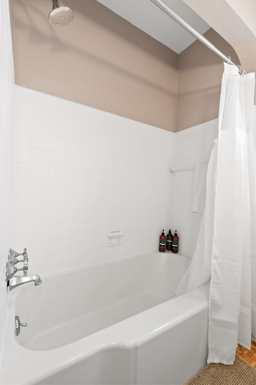 A modern bathtub with a sleek design and stylish bath products.