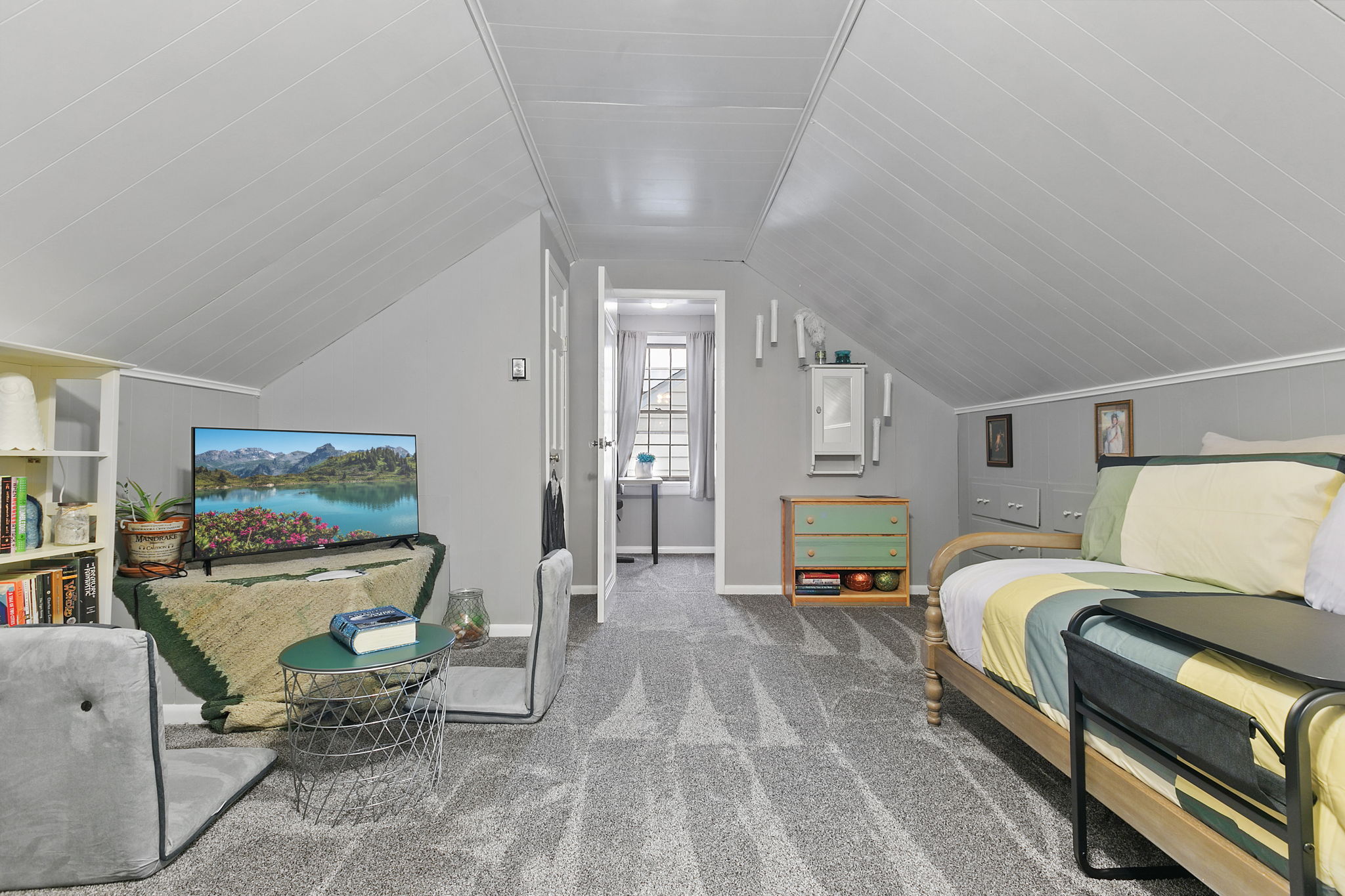 Cozy attic room with charming decor and an inviting atmosphere.