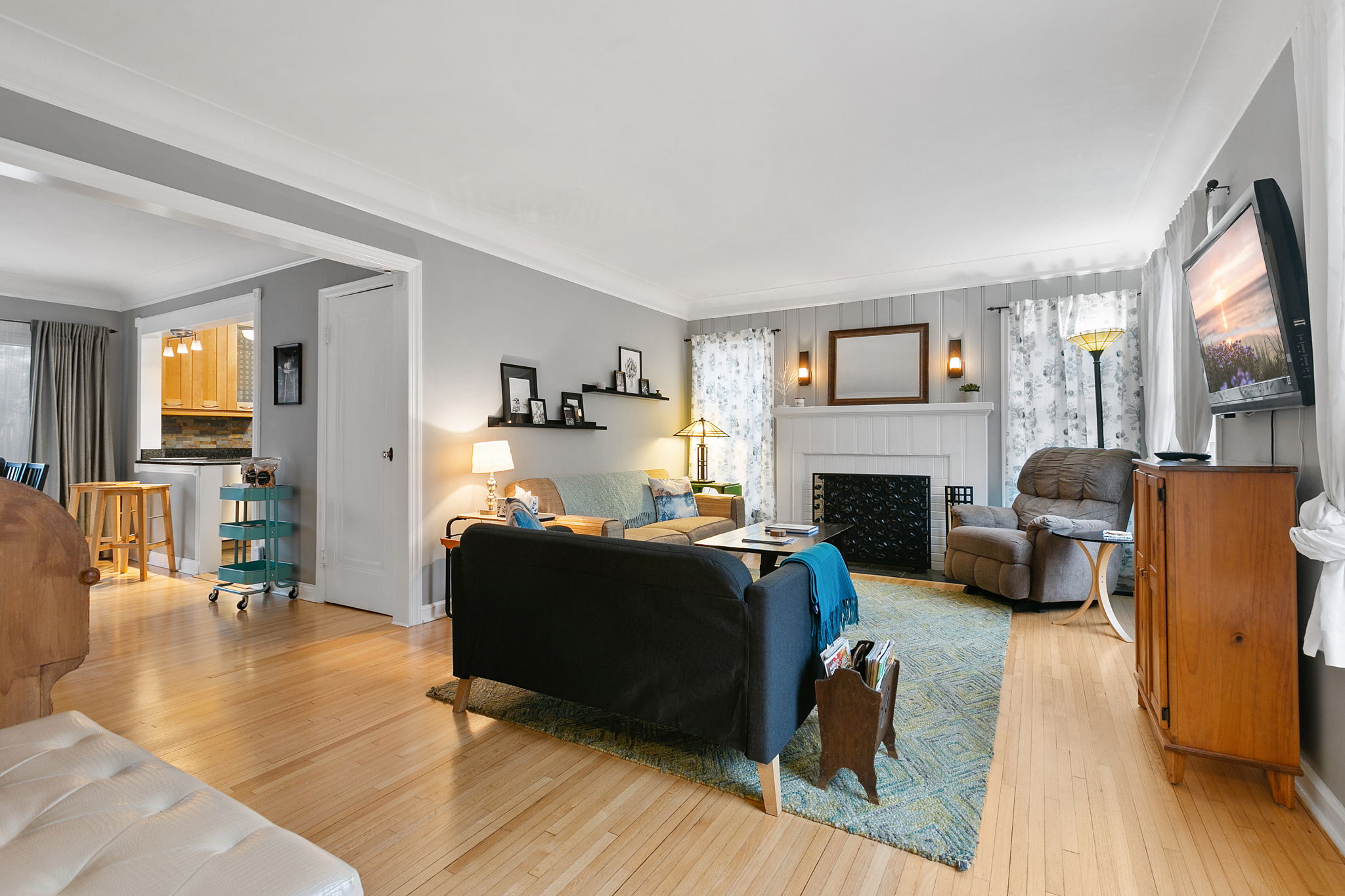 A cozy living room with a modern touch, featuring a fireplace and inviting furniture.