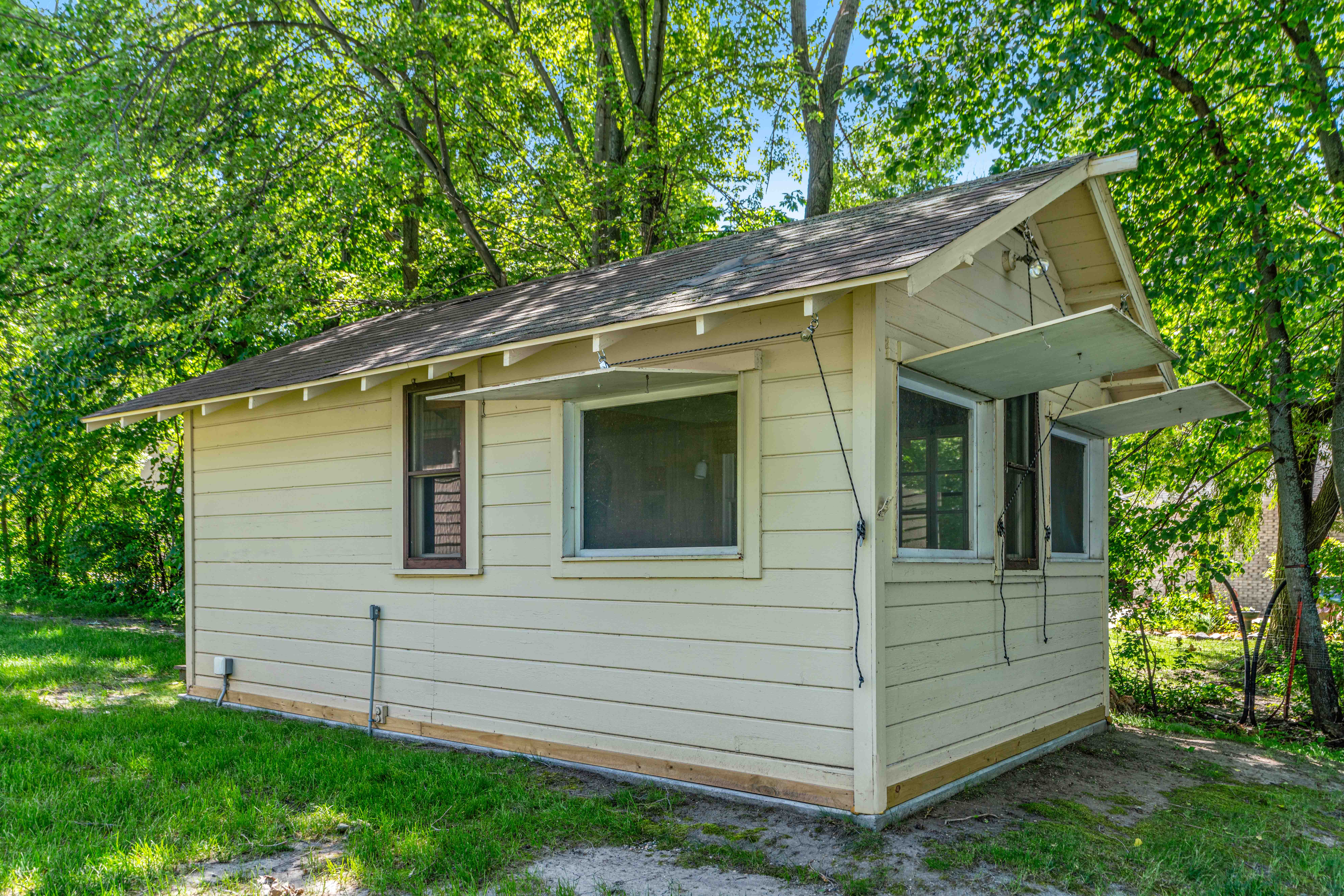 A quaint cabin surrounded by lush greenery.