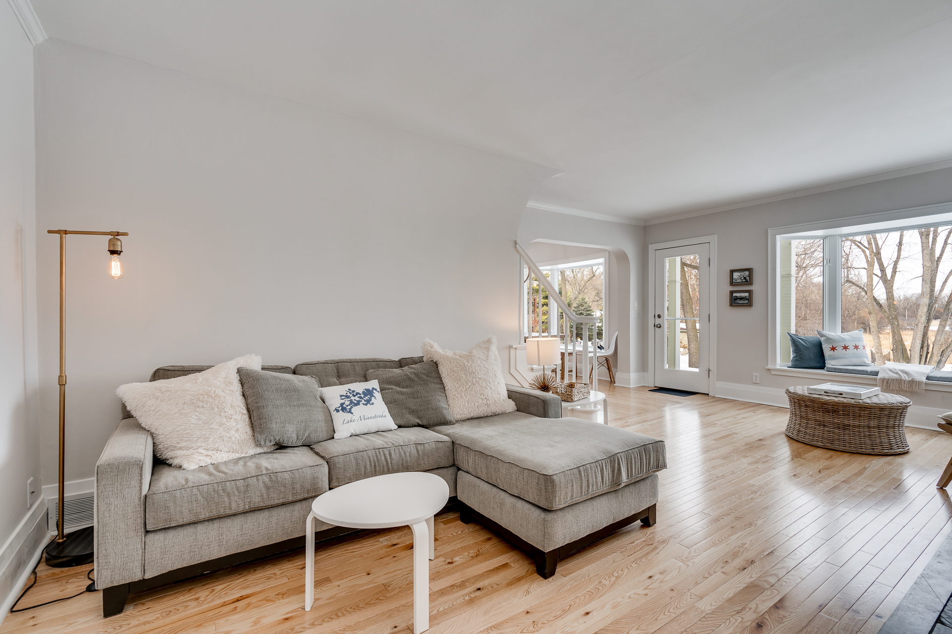 A bright and cozy living room featuring a gray sectional sofa and natural light.