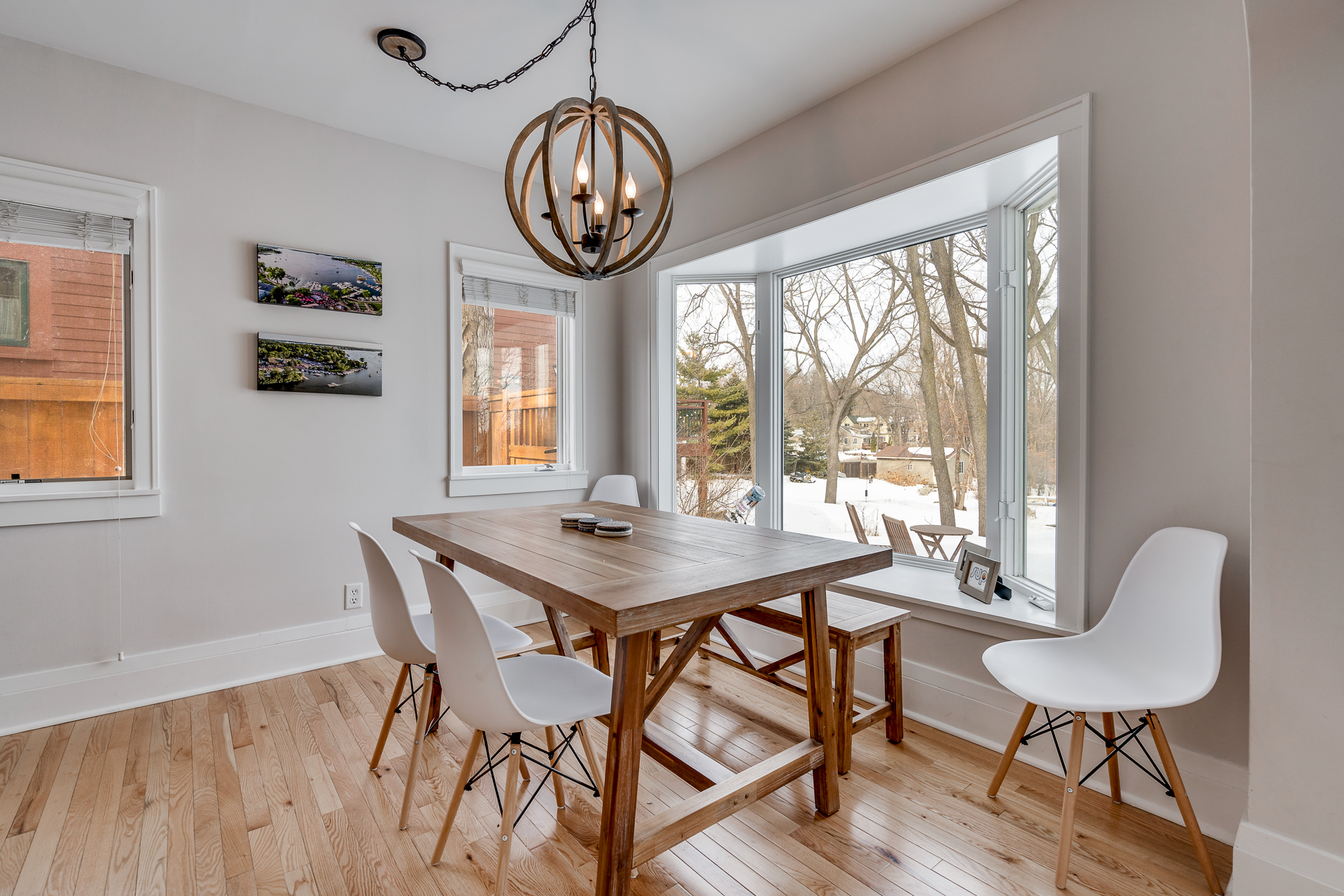 A cozy dining area with a rustic wooden table under an elegant chandelier.
