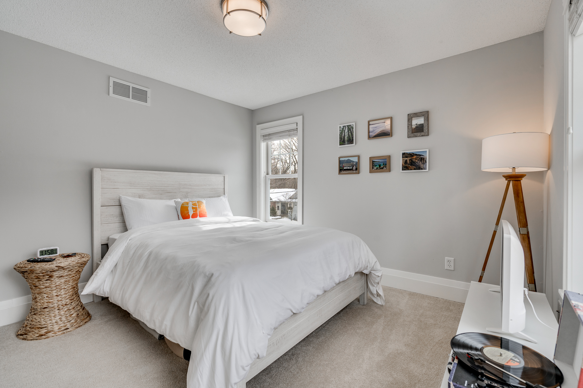 A serene modern bedroom with a cozy aesthetic and personal touches.