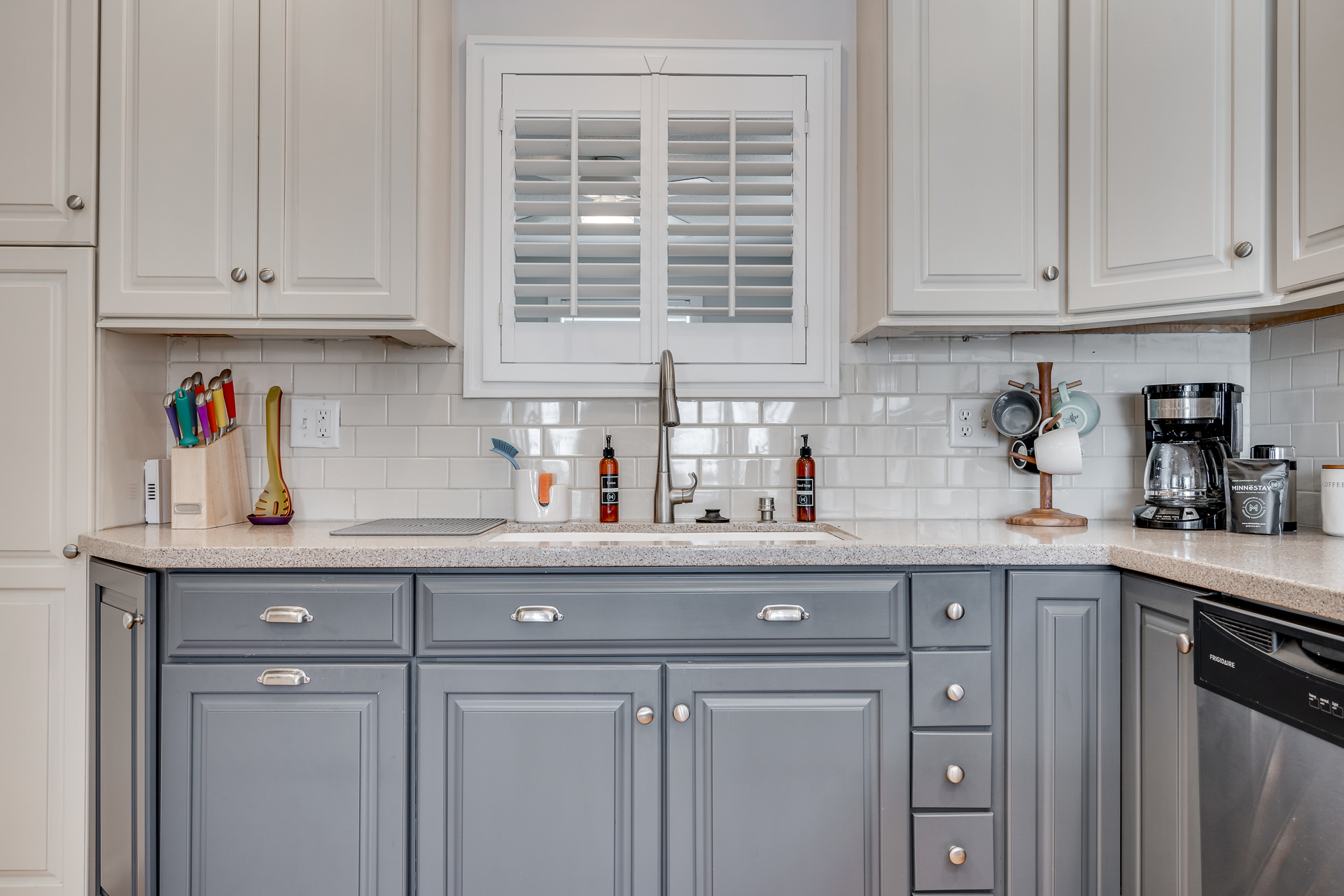 A modern kitchen with grey cabinets and a cozy design.