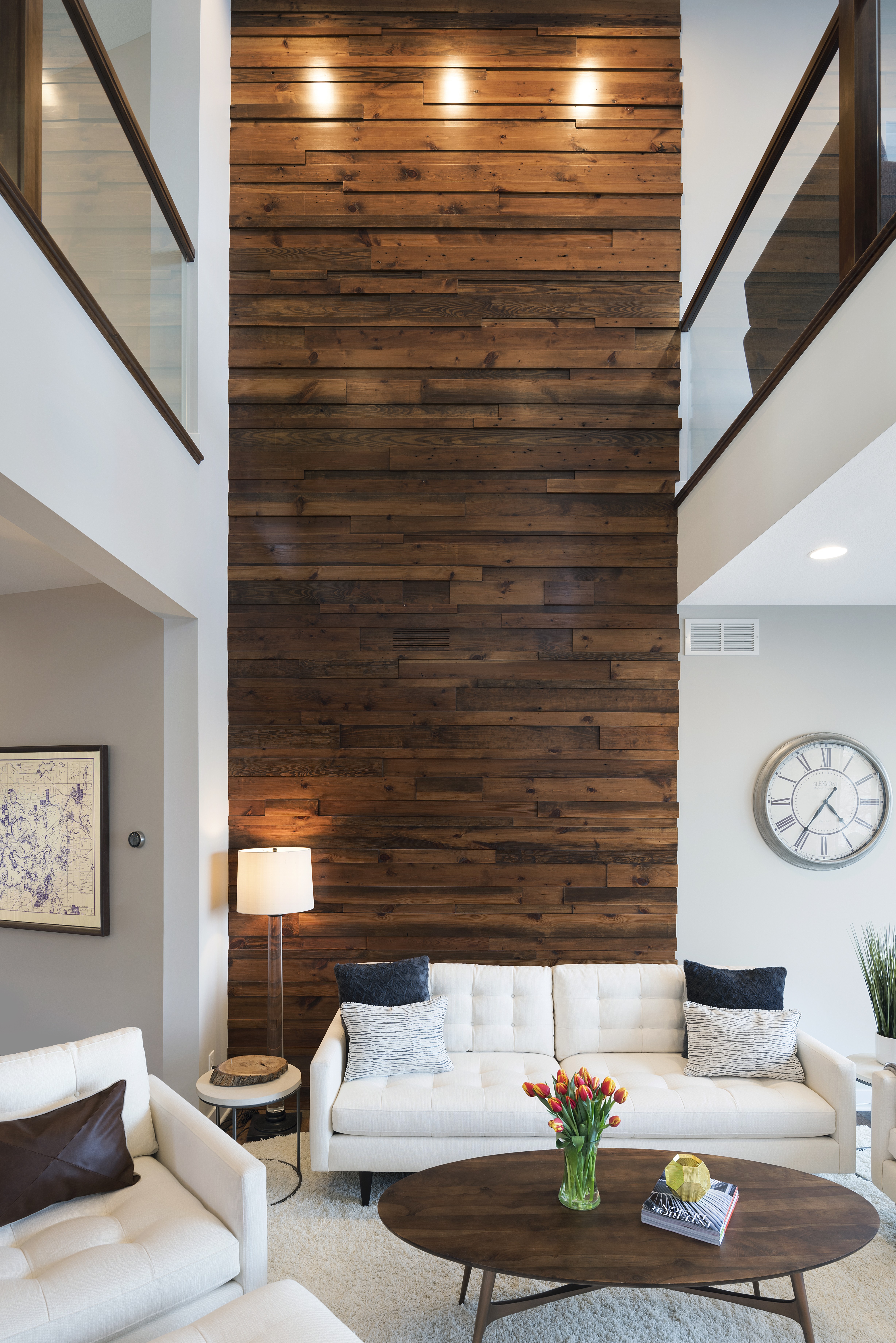 A modern living room featuring a striking wood accent wall and stylish decor.