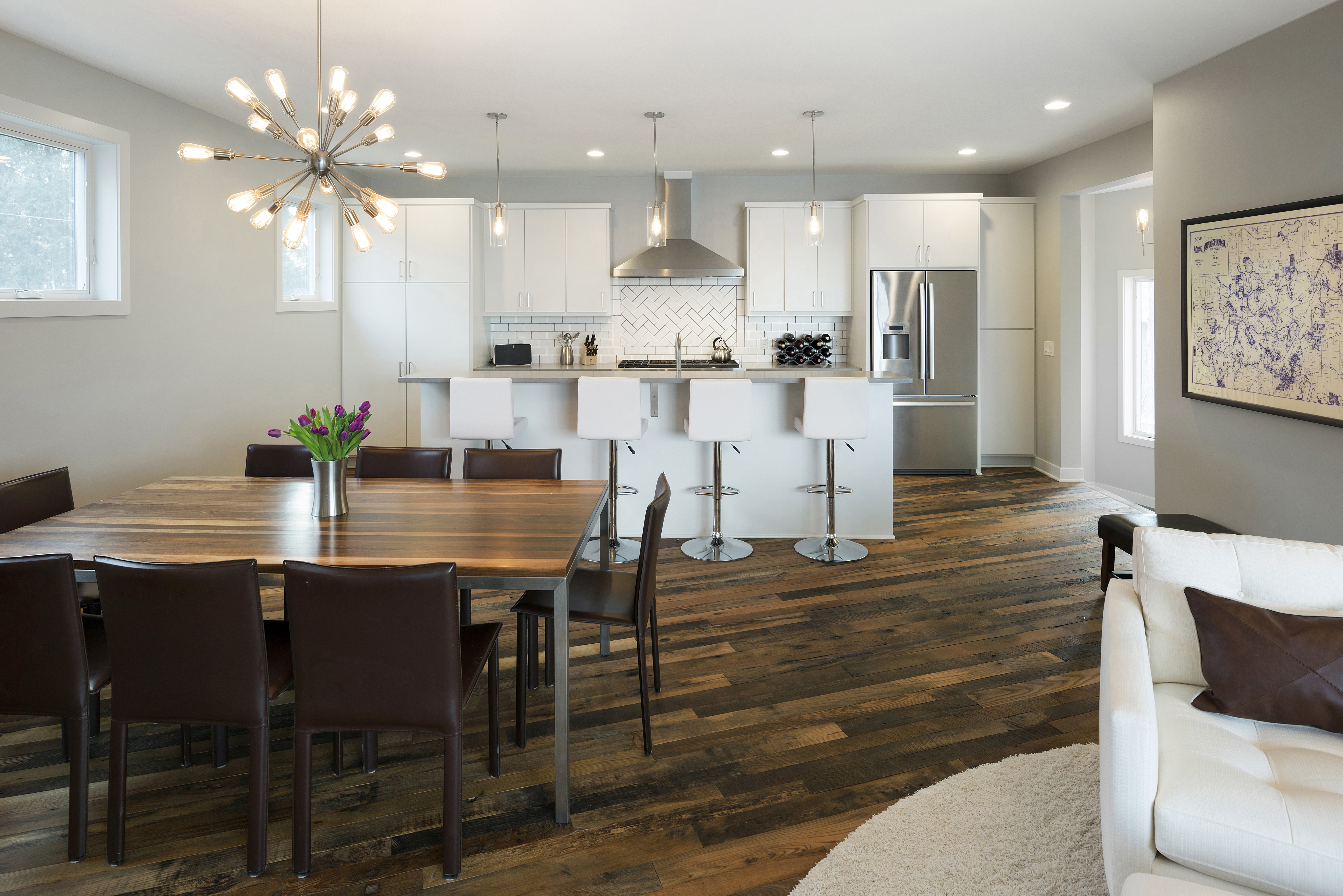 A modern kitchen and dining area with stylish decor and vibrant tulips.