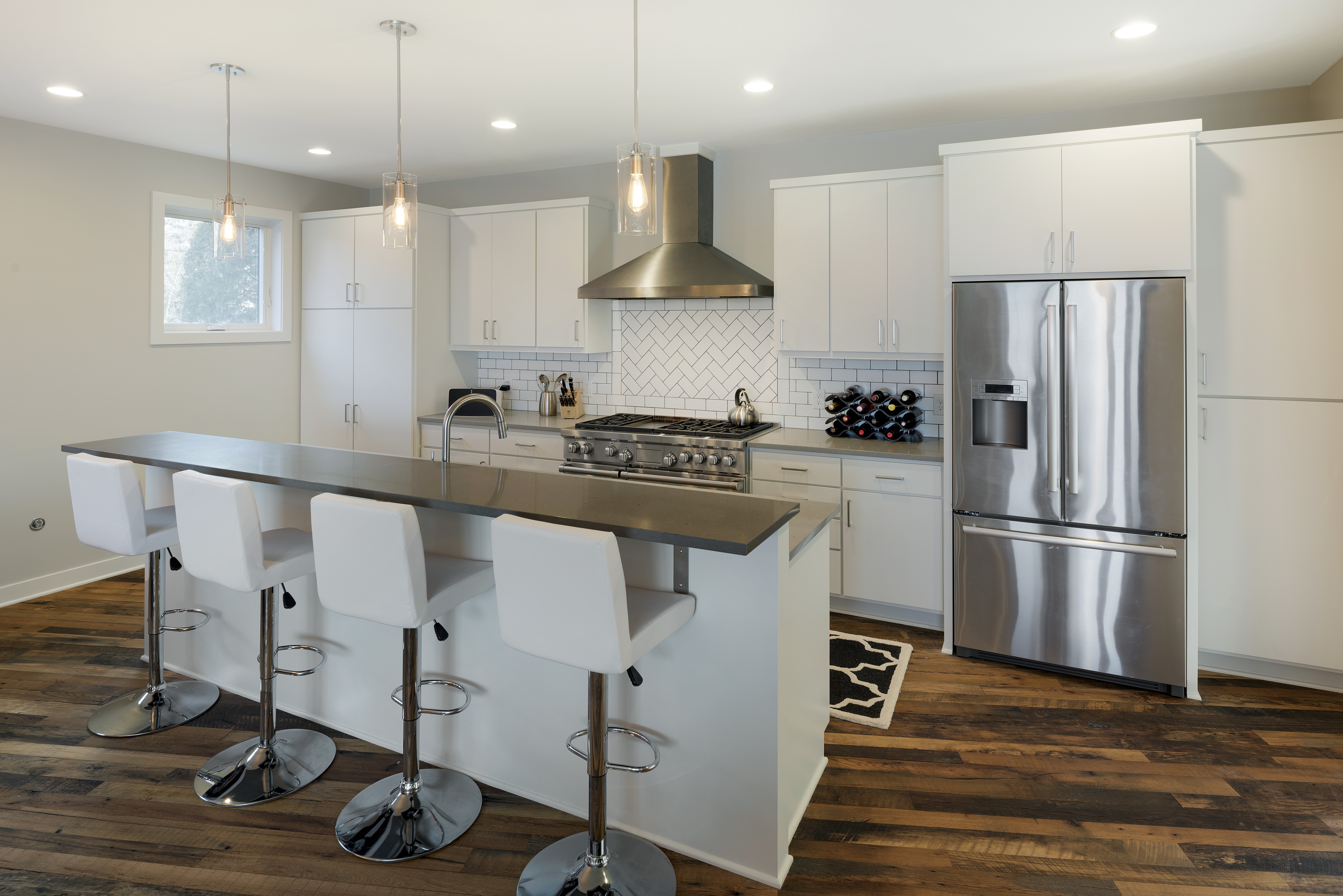 A contemporary kitchen with a sleek design and modern amenities.