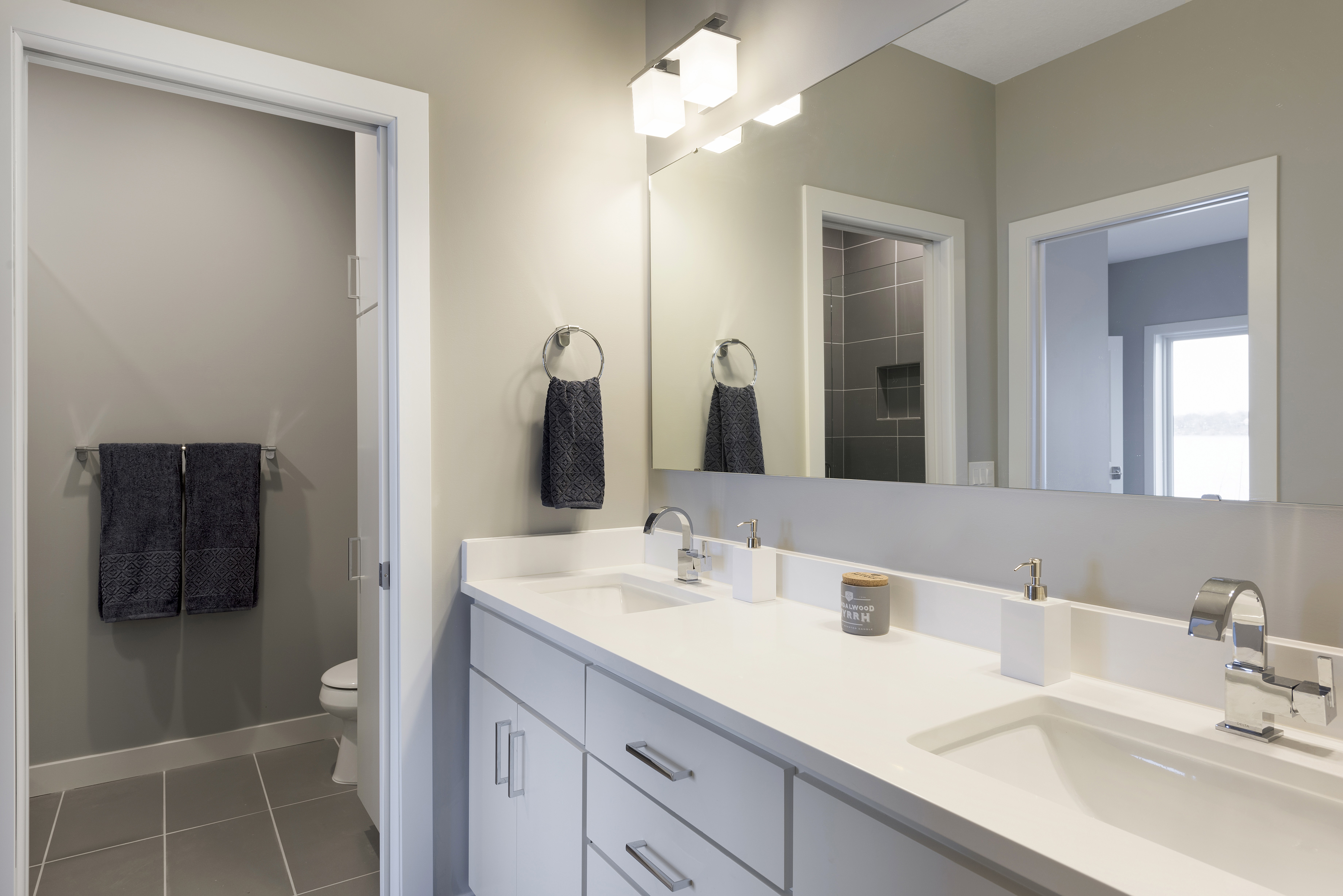 A modern bathroom with double vanity and stylish fixtures.