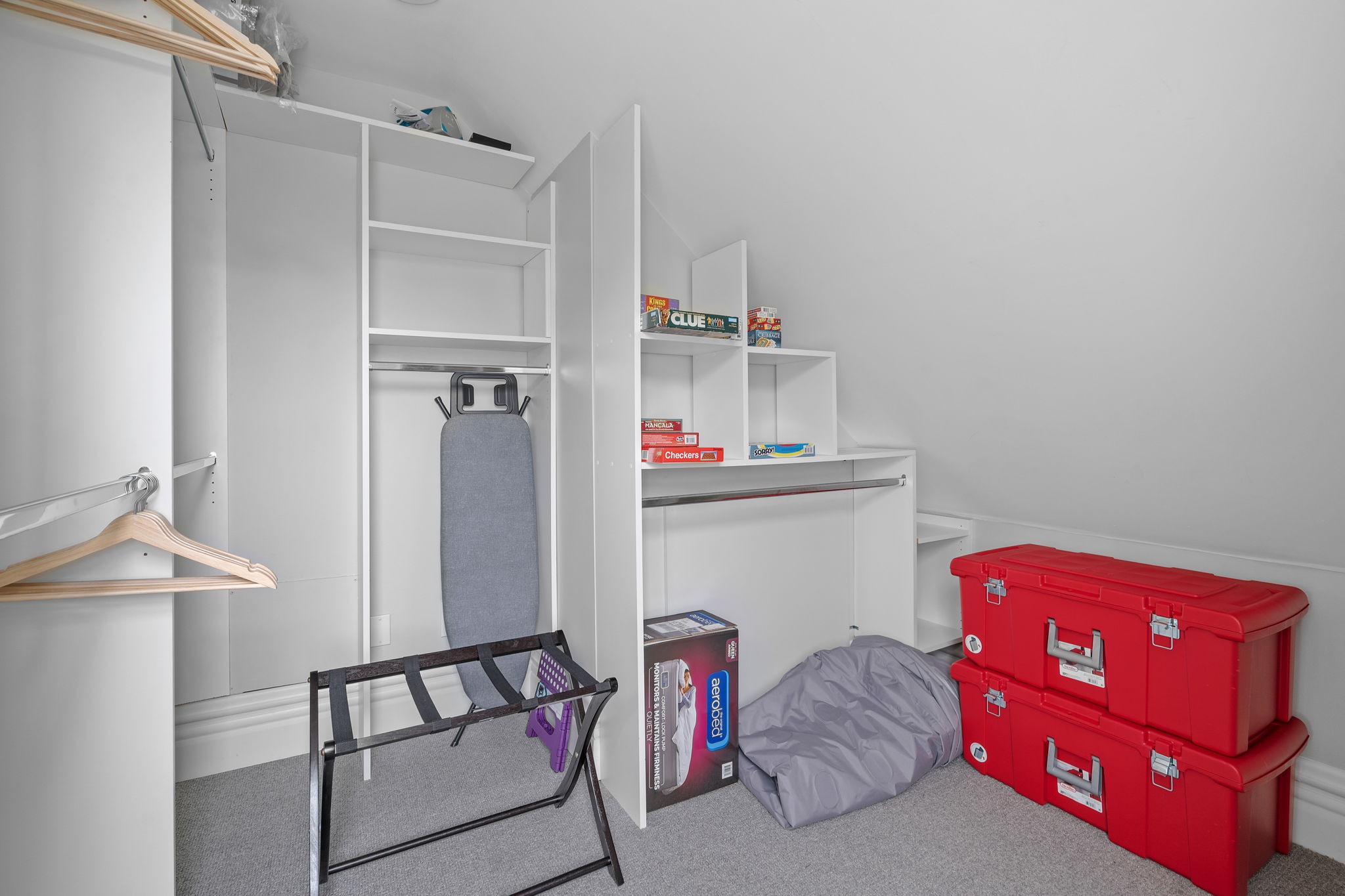 A well-organized attic space with practical storage solutions and a cozy touch.