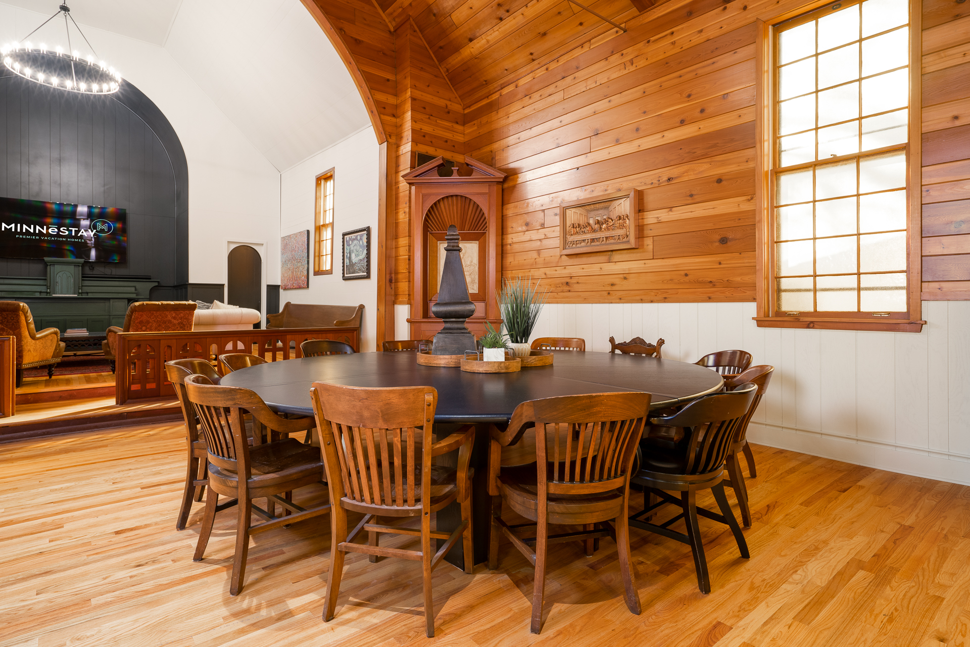 A warm and inviting gathering space with a central table and wooden decor.