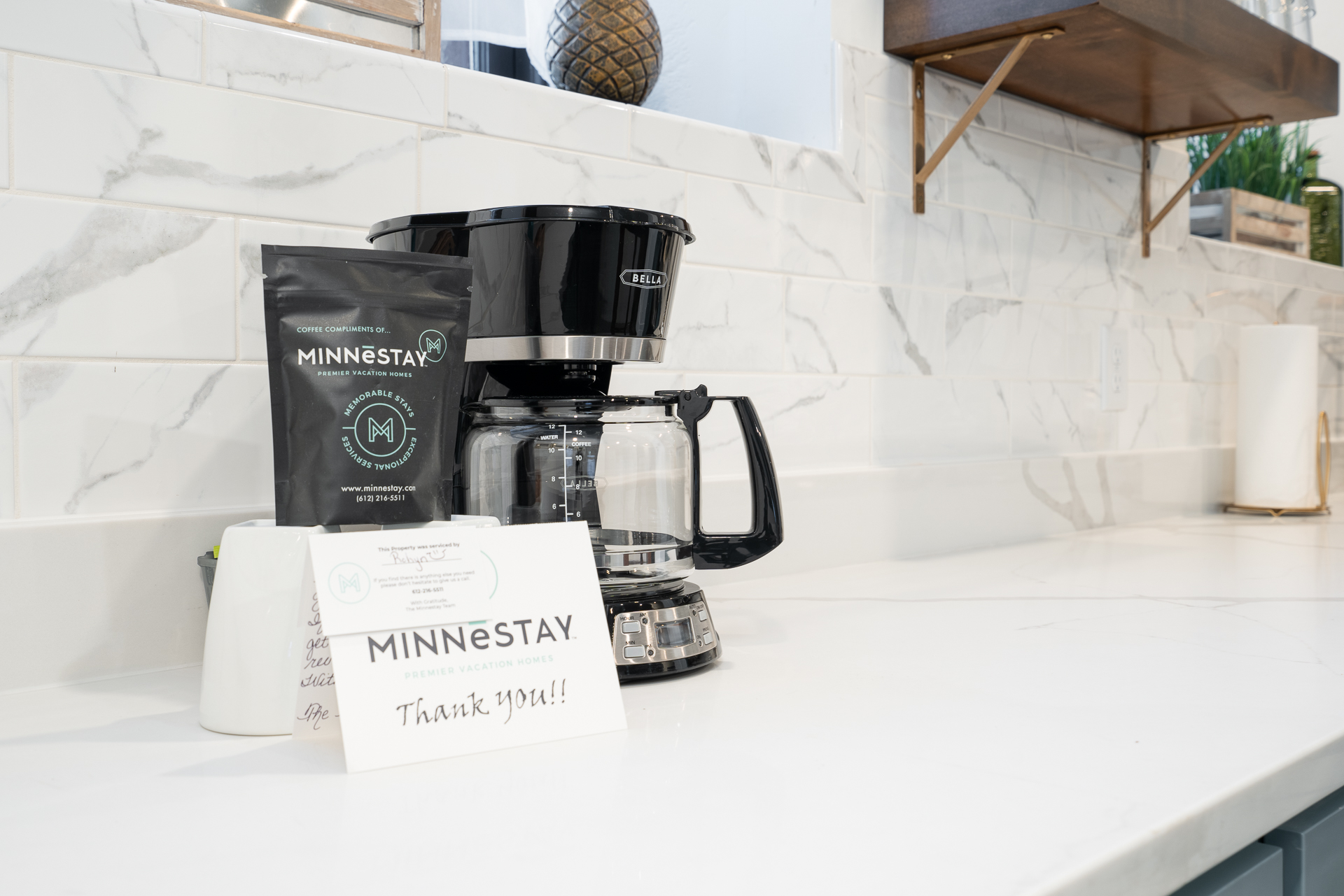A modern coffee setup featuring a Bella coffee maker and complimentary coffee from MINNESTAY.