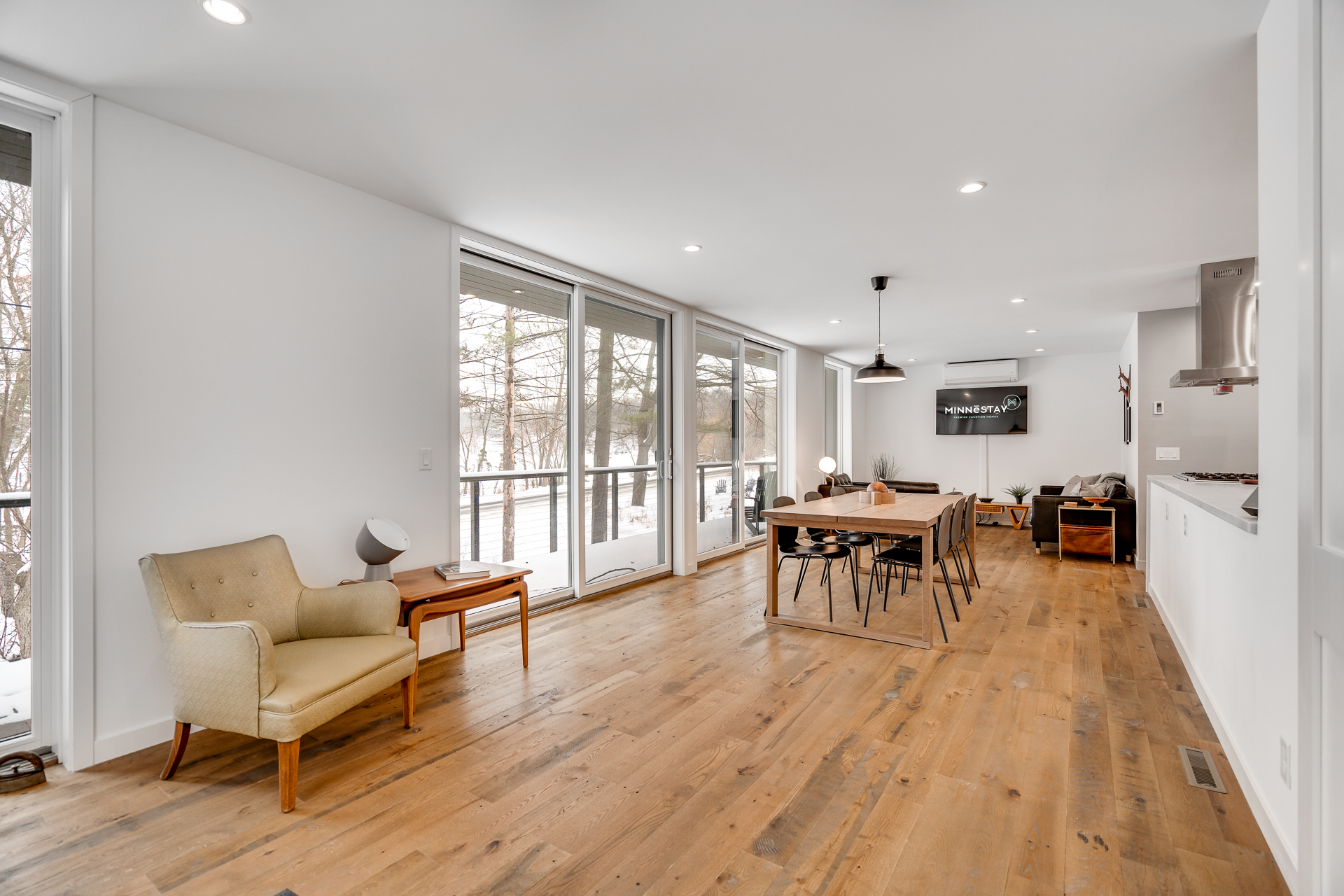 Modern and spacious living area with natural light and cozy furnishings.