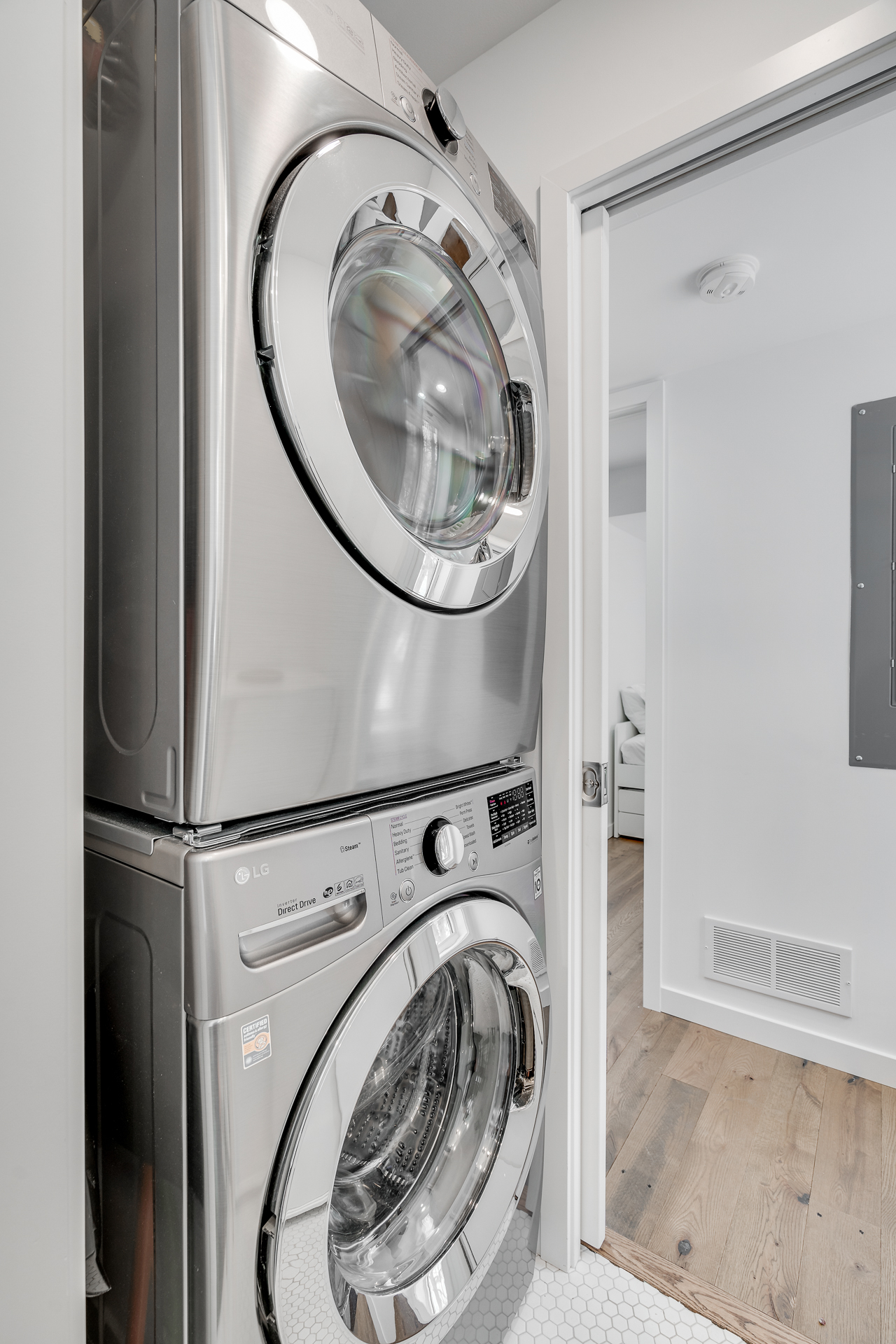 A modern stacked washer and dryer in a contemporary laundry space.