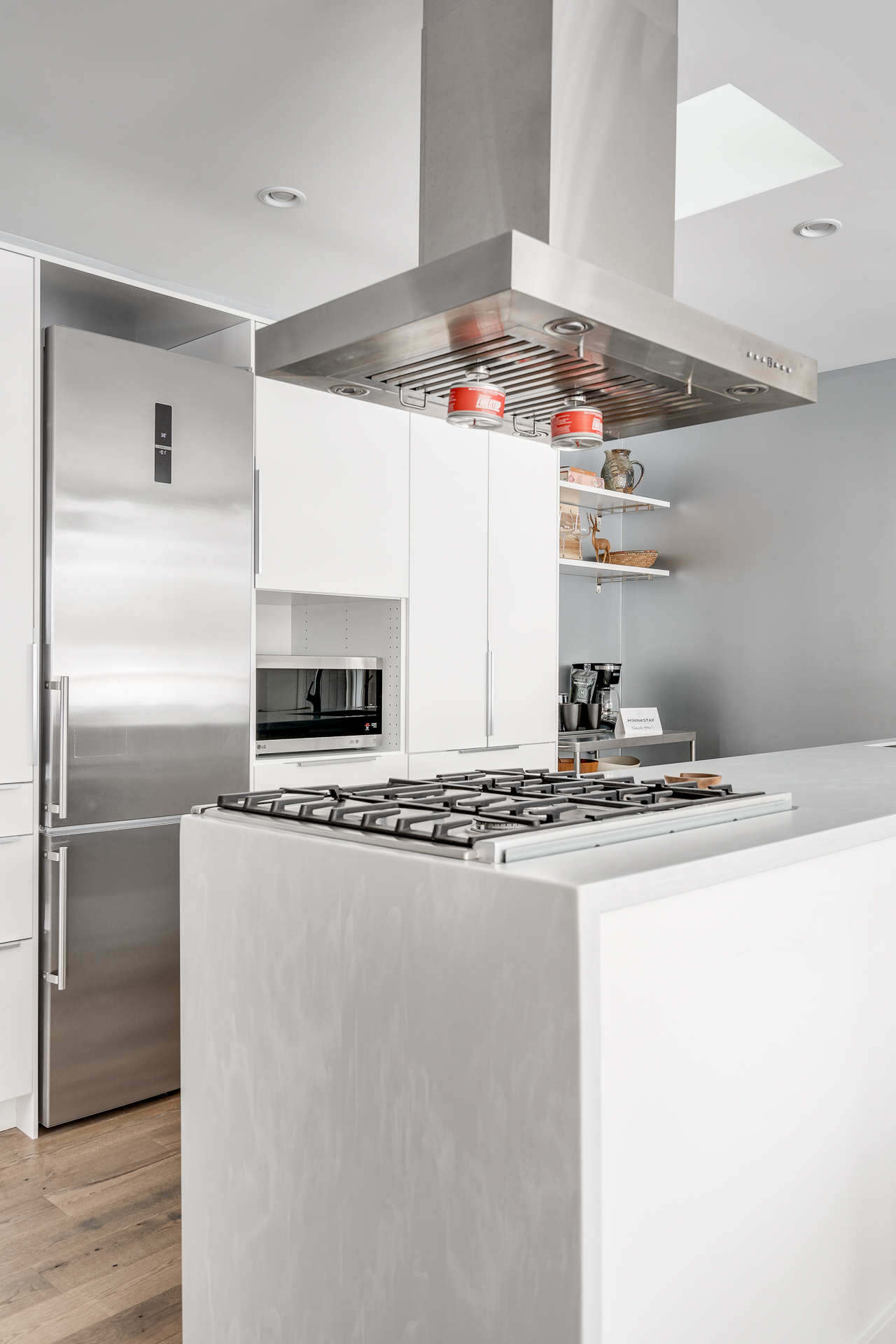 A stylish modern kitchen with a central cooking island and stainless steel appliances.