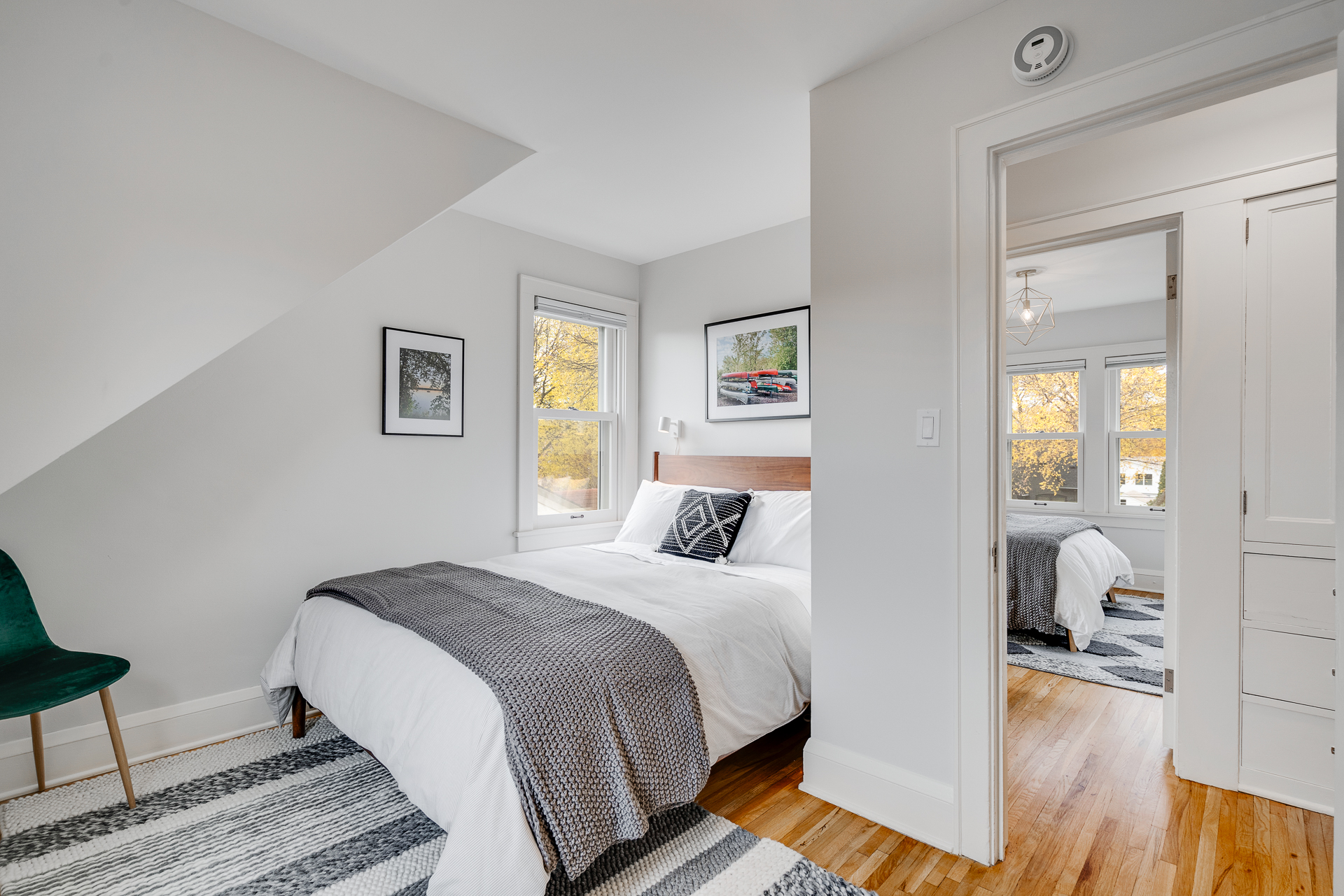 A modern and cozy bedroom adorned with natural light and stylish decor.