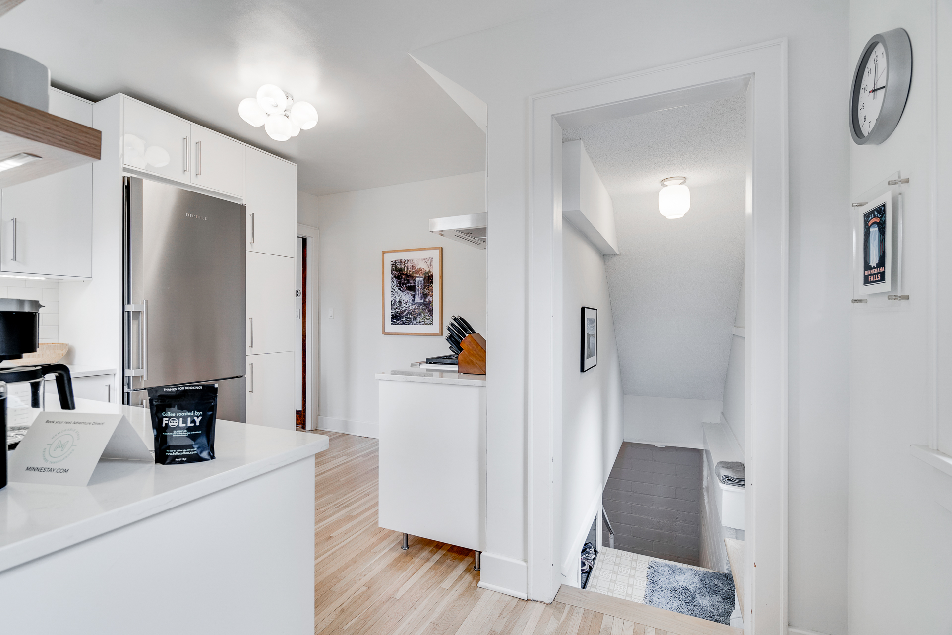 A stylish and airy kitchen leading to a staircase.