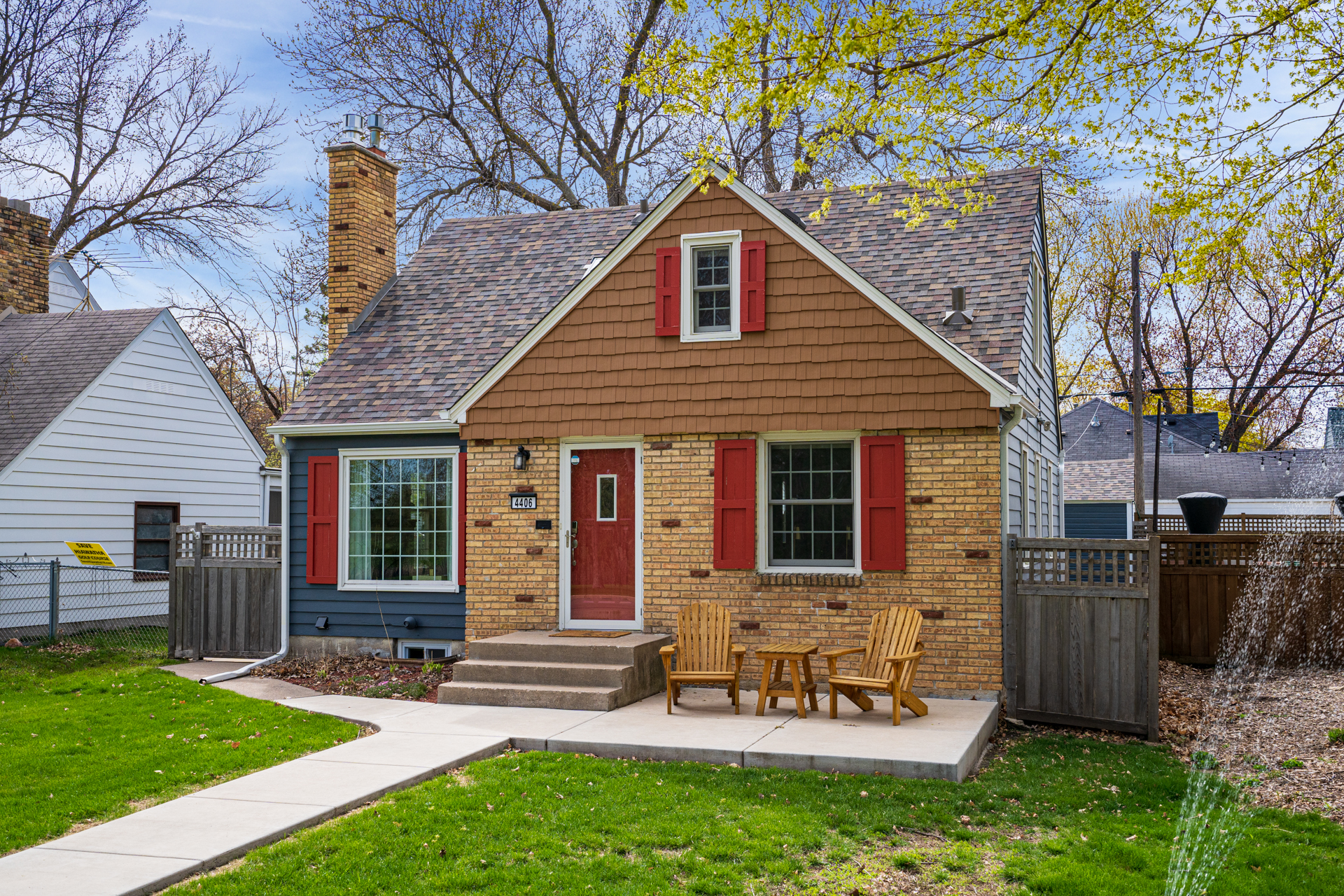 A charming house with red shutters and a cozy patio.