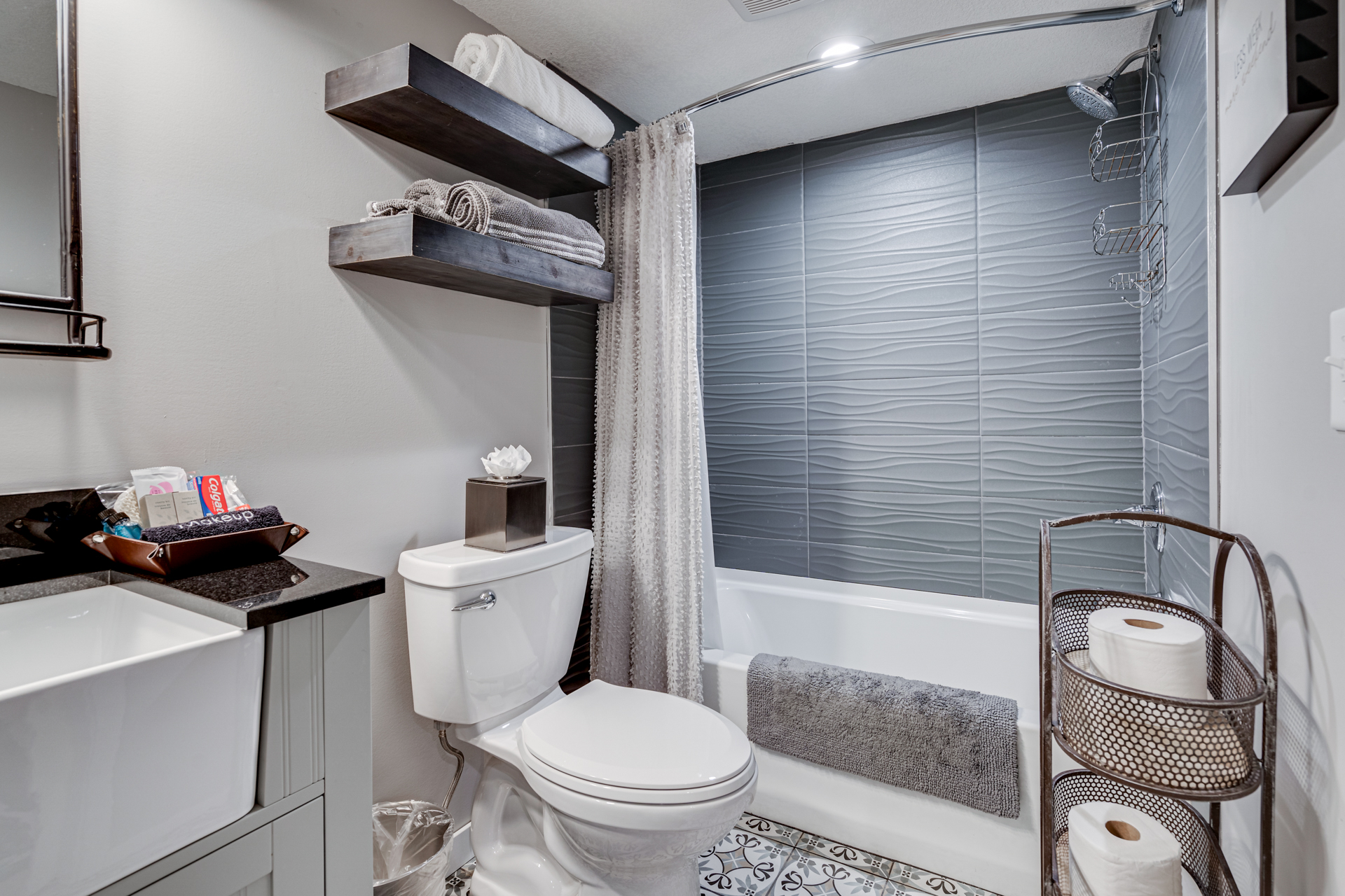 A modern bathroom featuring a stylish design with gray tones and elegant details.