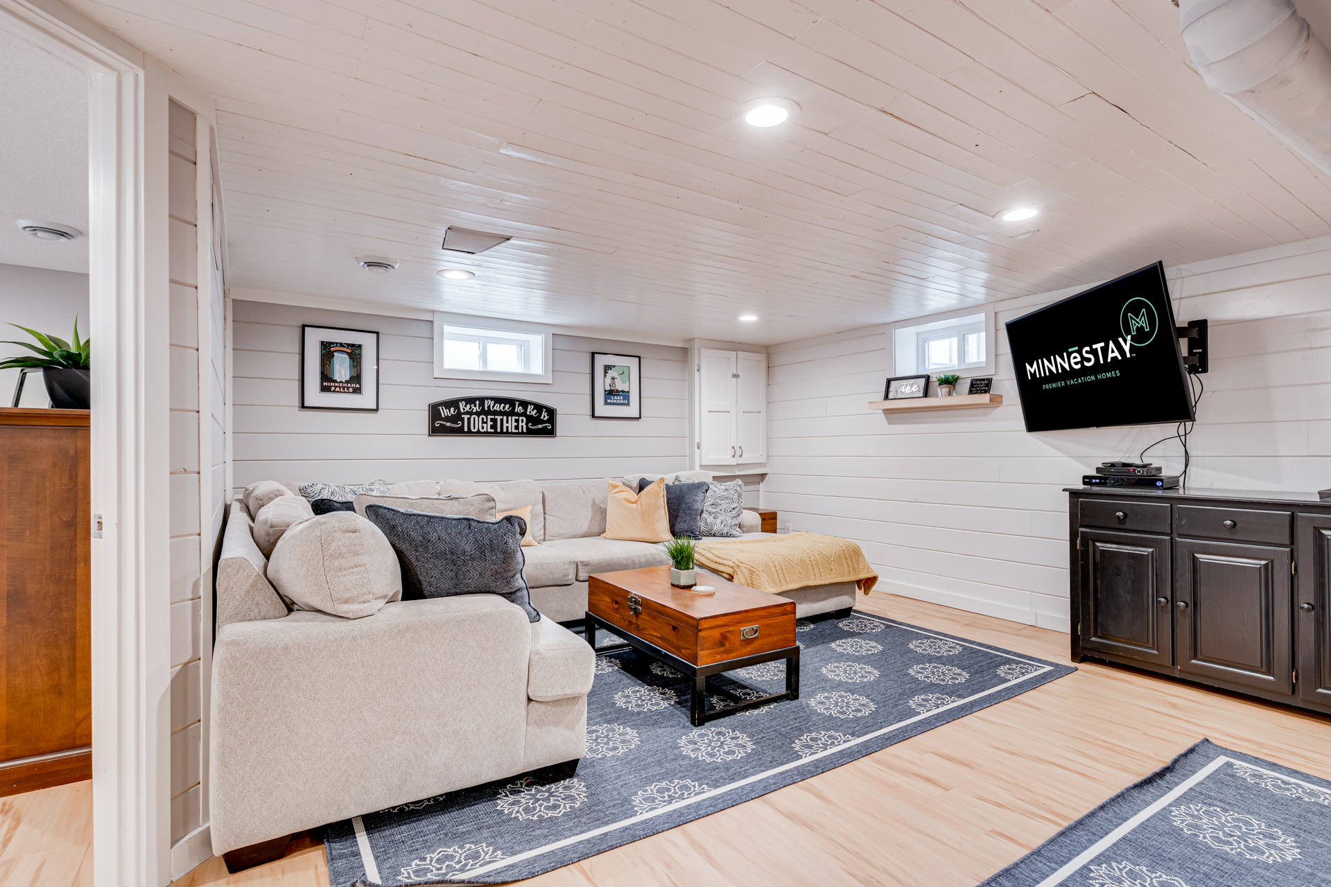 Cozy and inviting finished basement living area with modern decor.