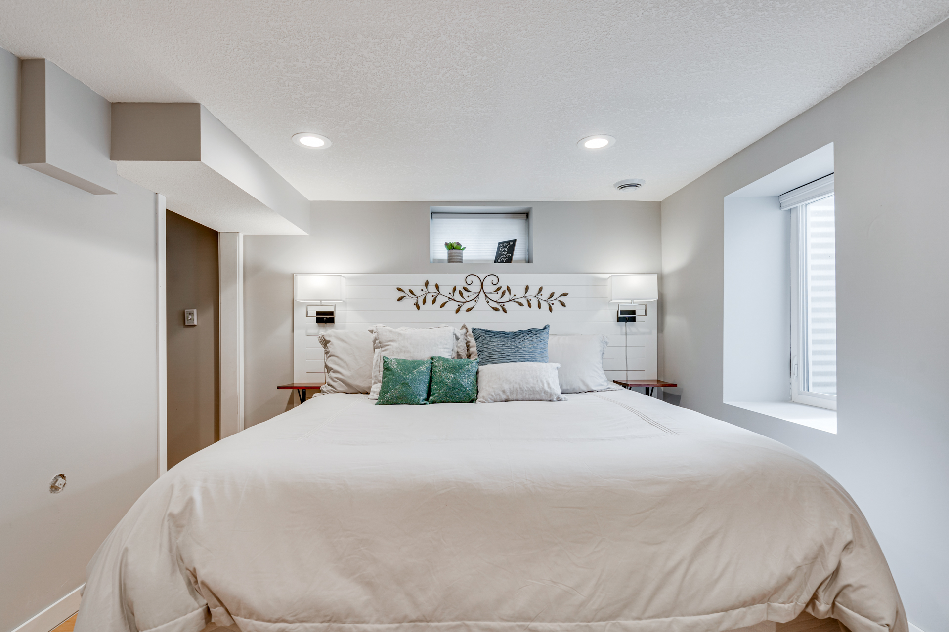 A cozy and modern bedroom featuring a stylish bed and elegant decor.