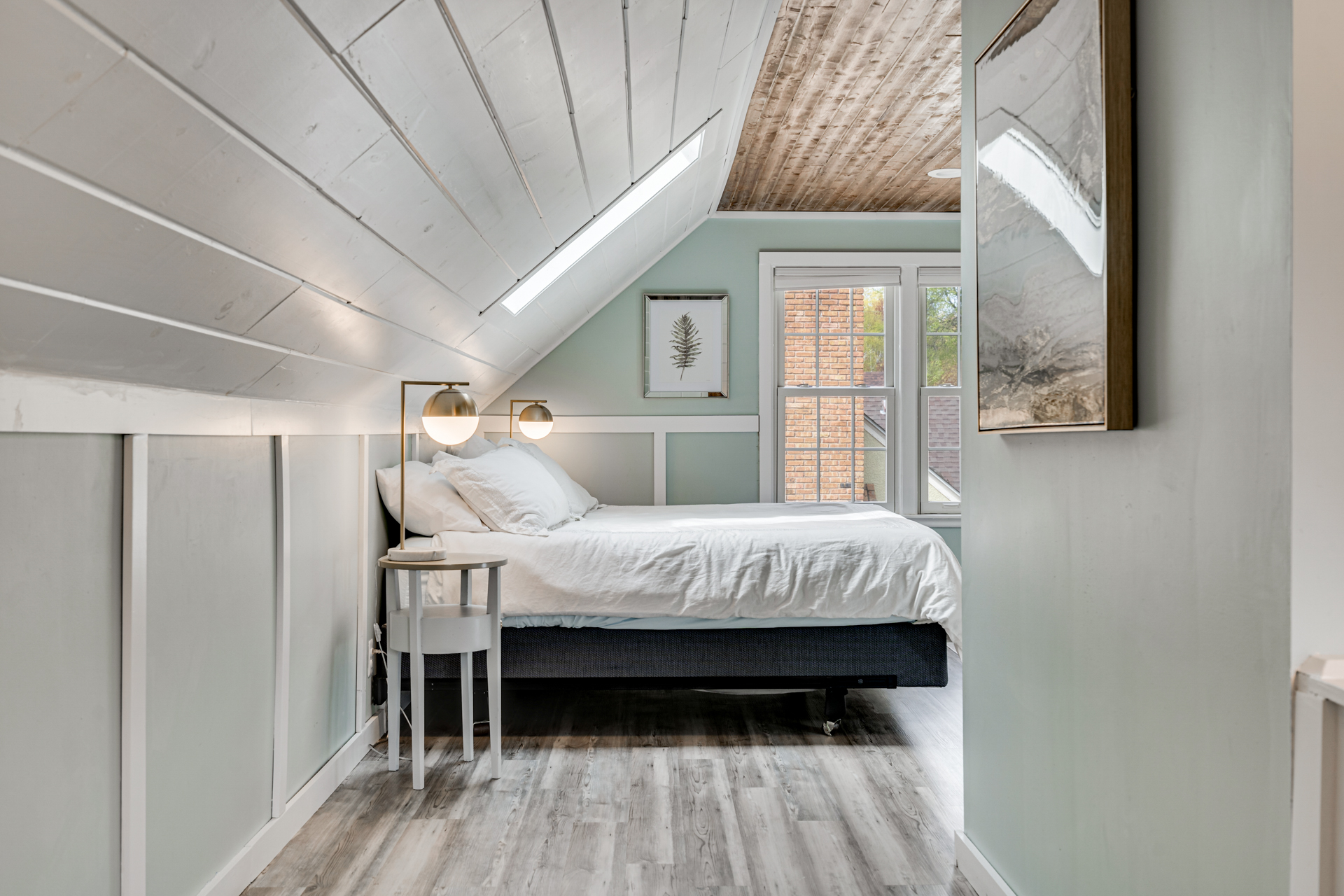 Cozy attic bedroom with sloping ceiling and modern decor.
