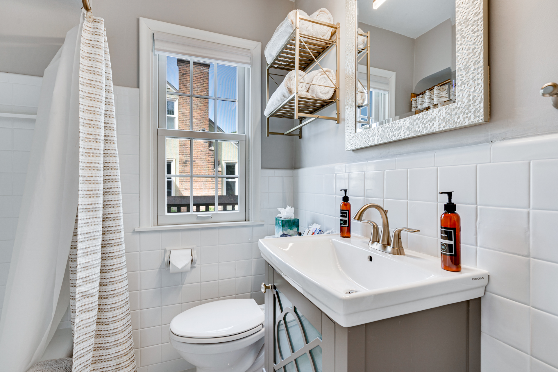 Modern bathroom with stylish decor and natural light.