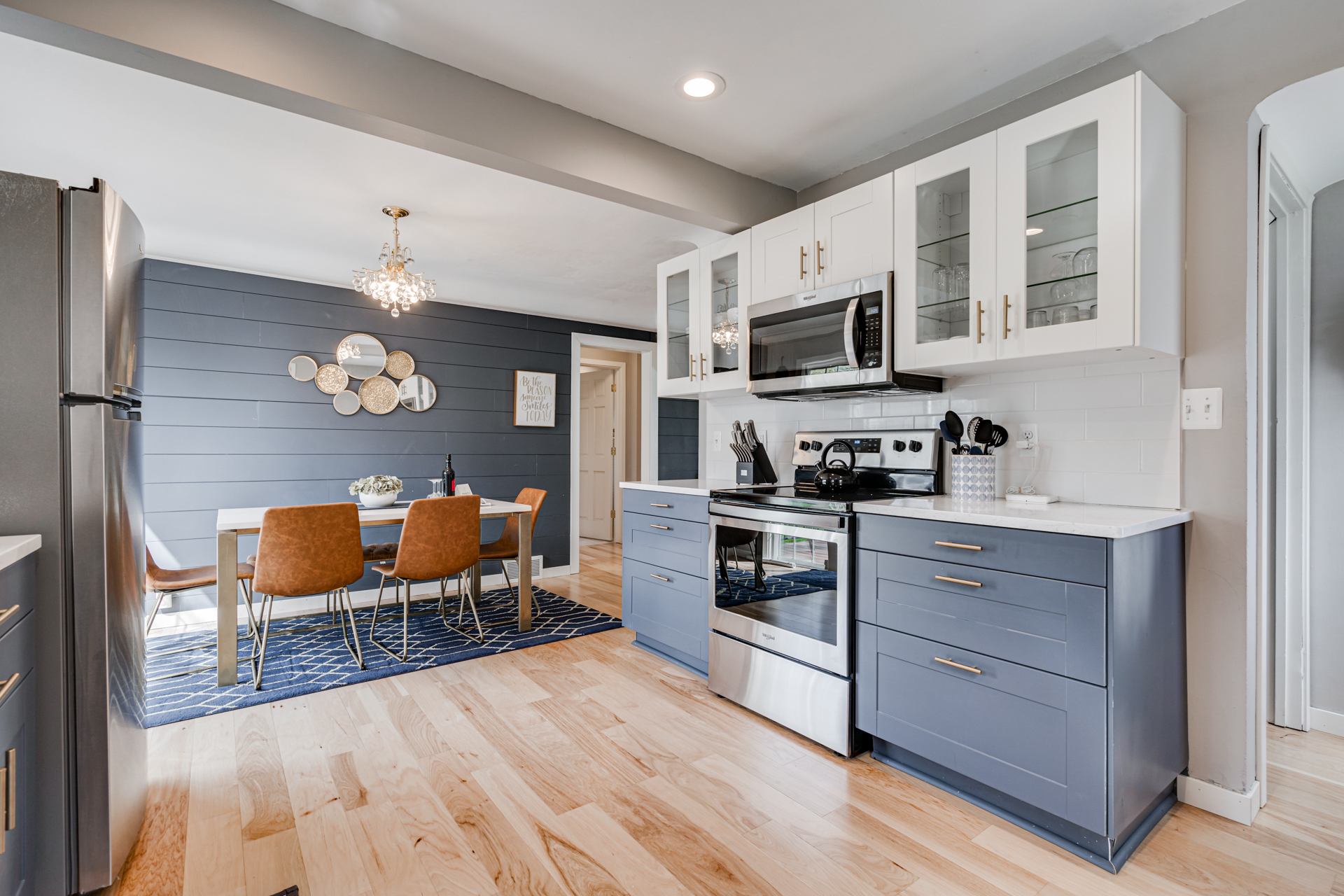 Modern kitchen design featuring navy blue cabinets and a cozy dining area.