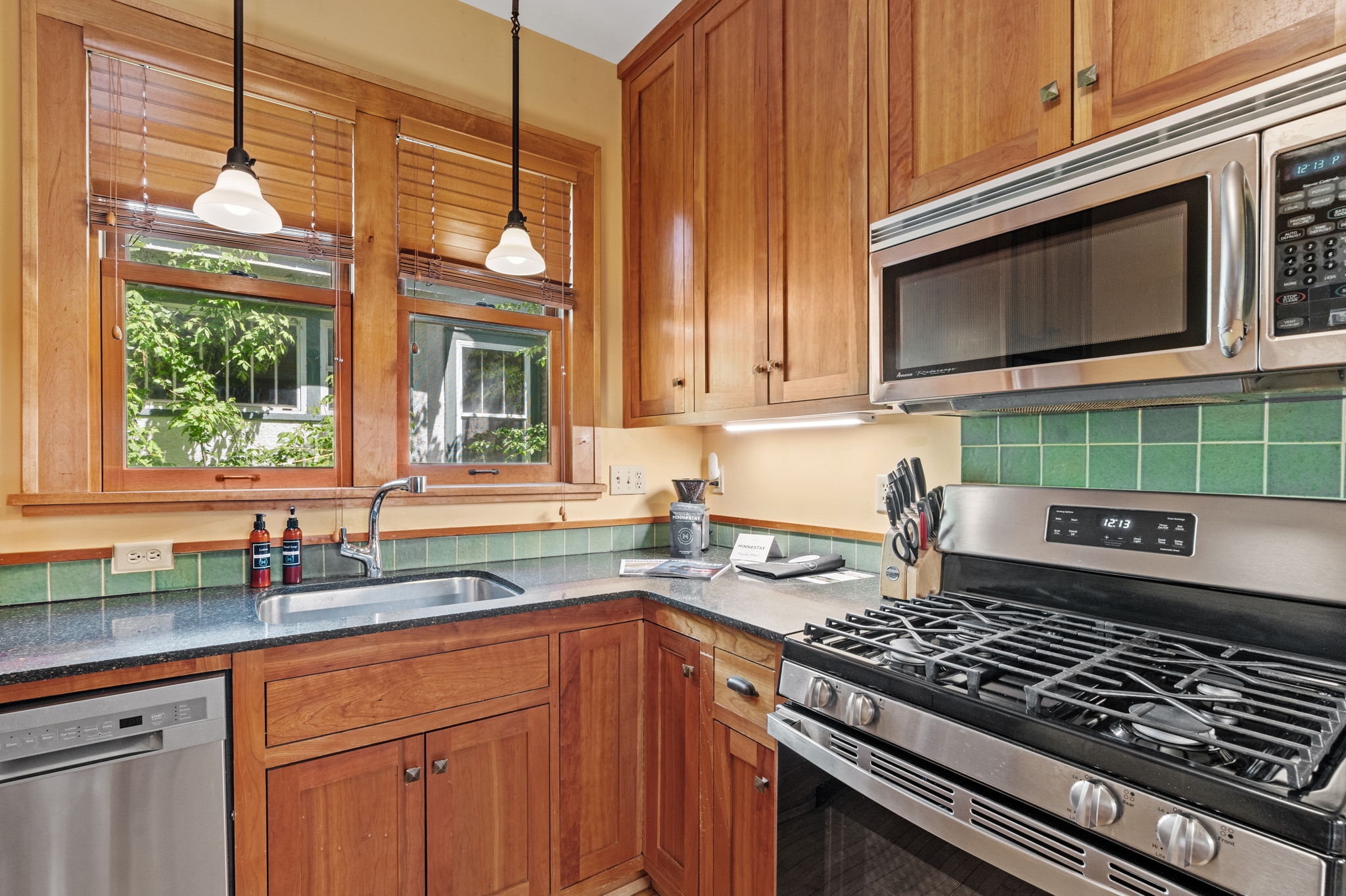 A warm and inviting kitchen with wooden cabinetry and modern appliances.