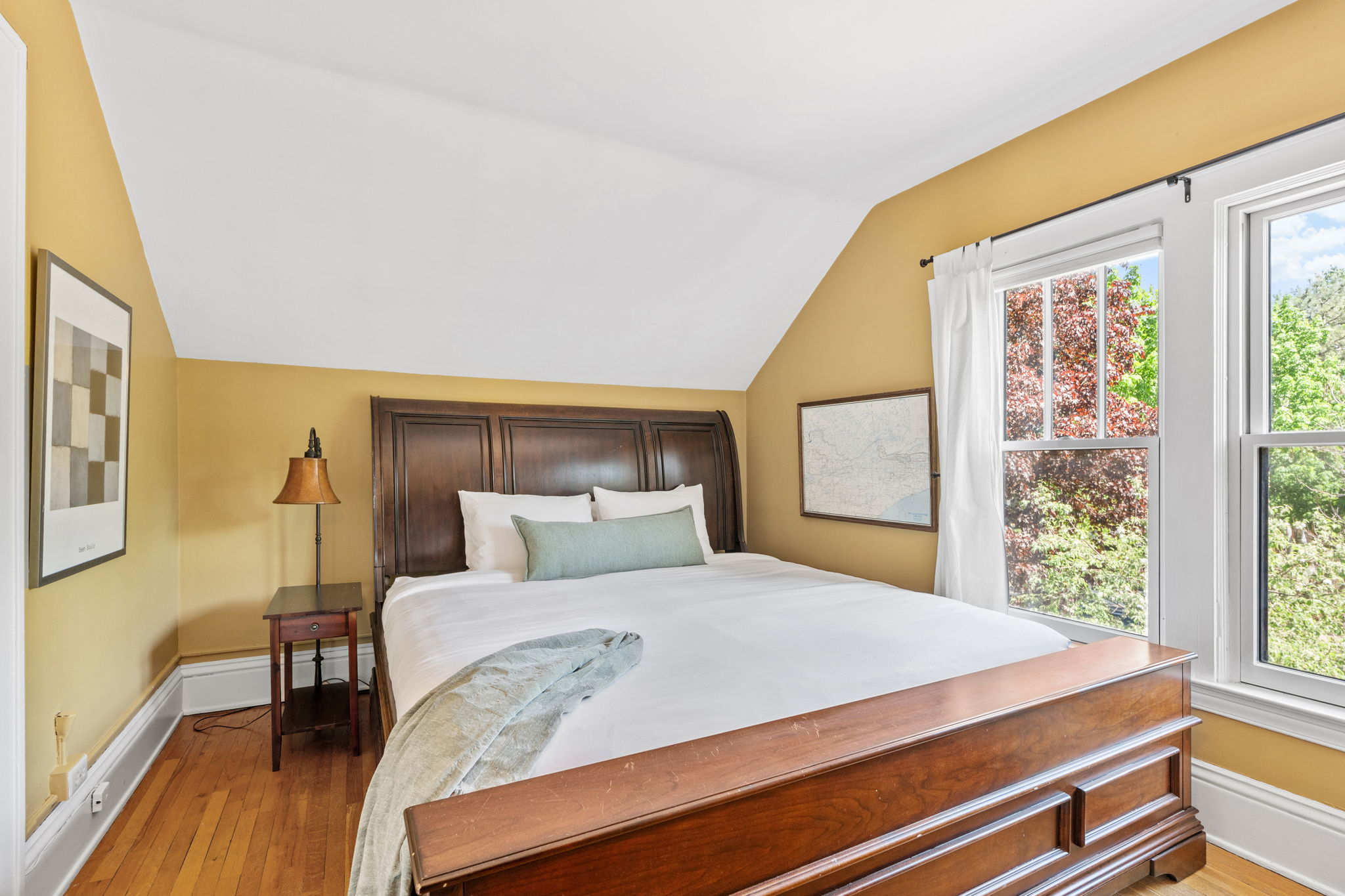 A cozy and inviting bedroom with warm tones and natural light.