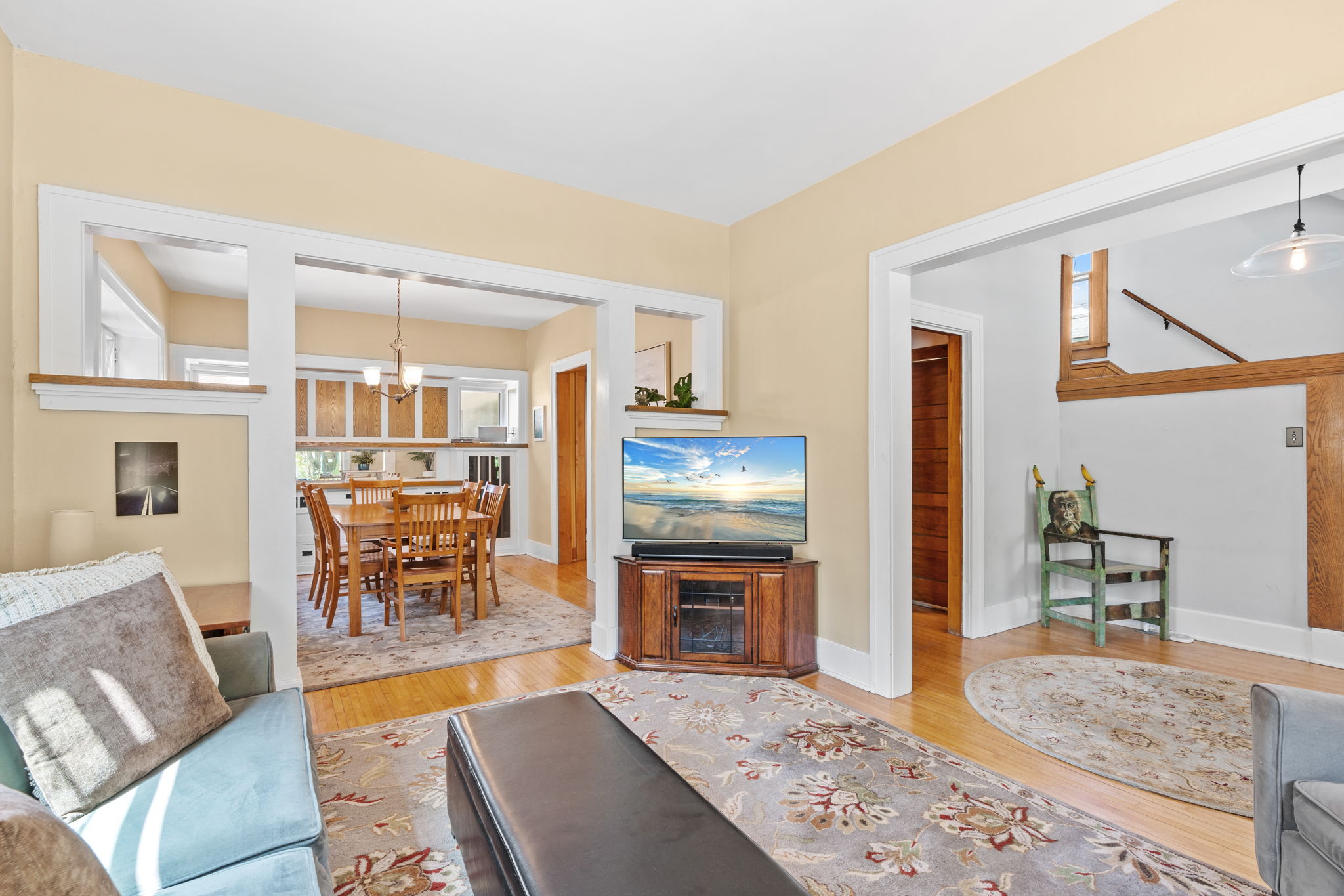 A cozy living area transitioning into a dining space, filled with natural light.