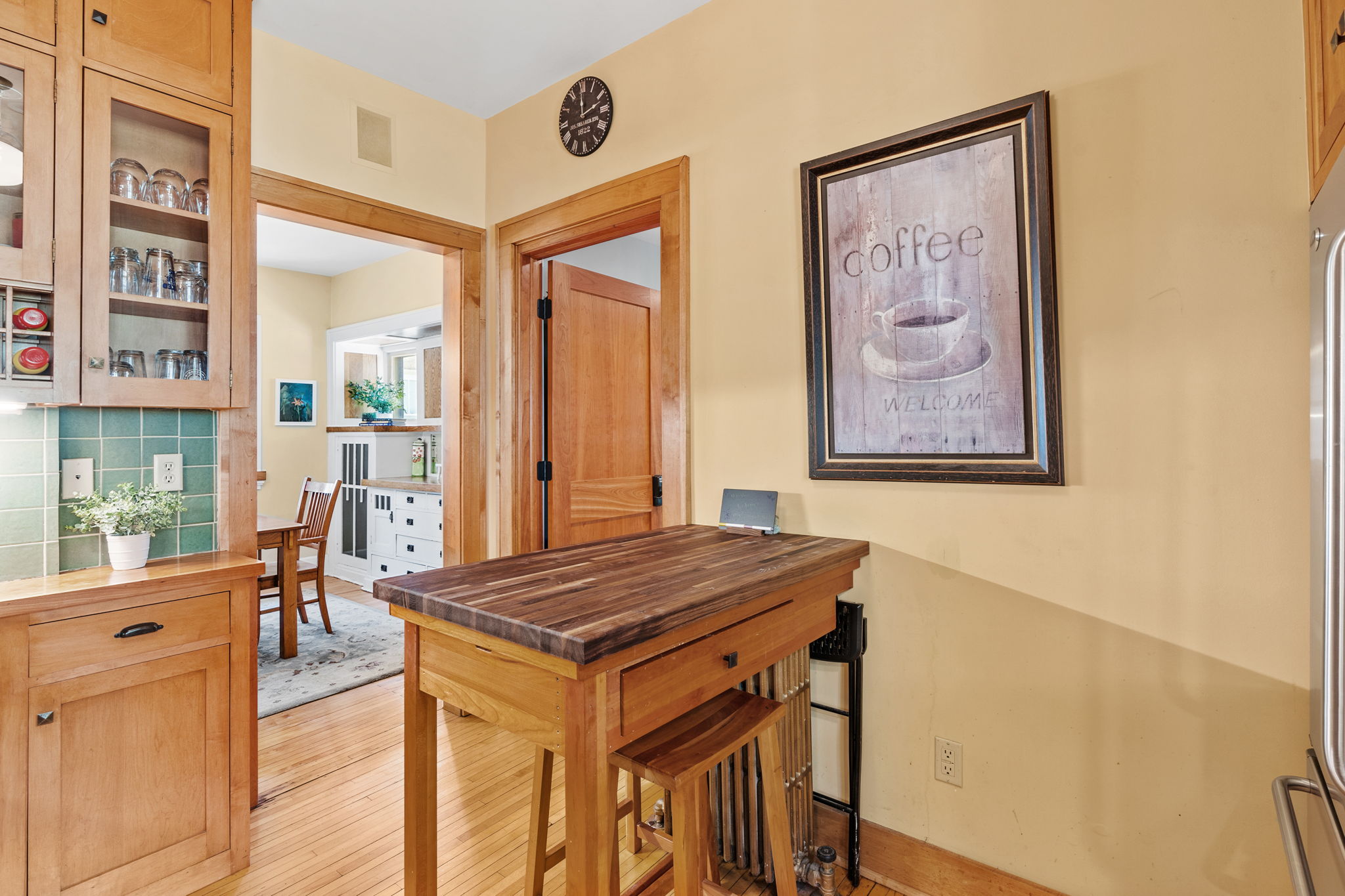 A cozy kitchen with wooden elements and a welcoming coffee theme.